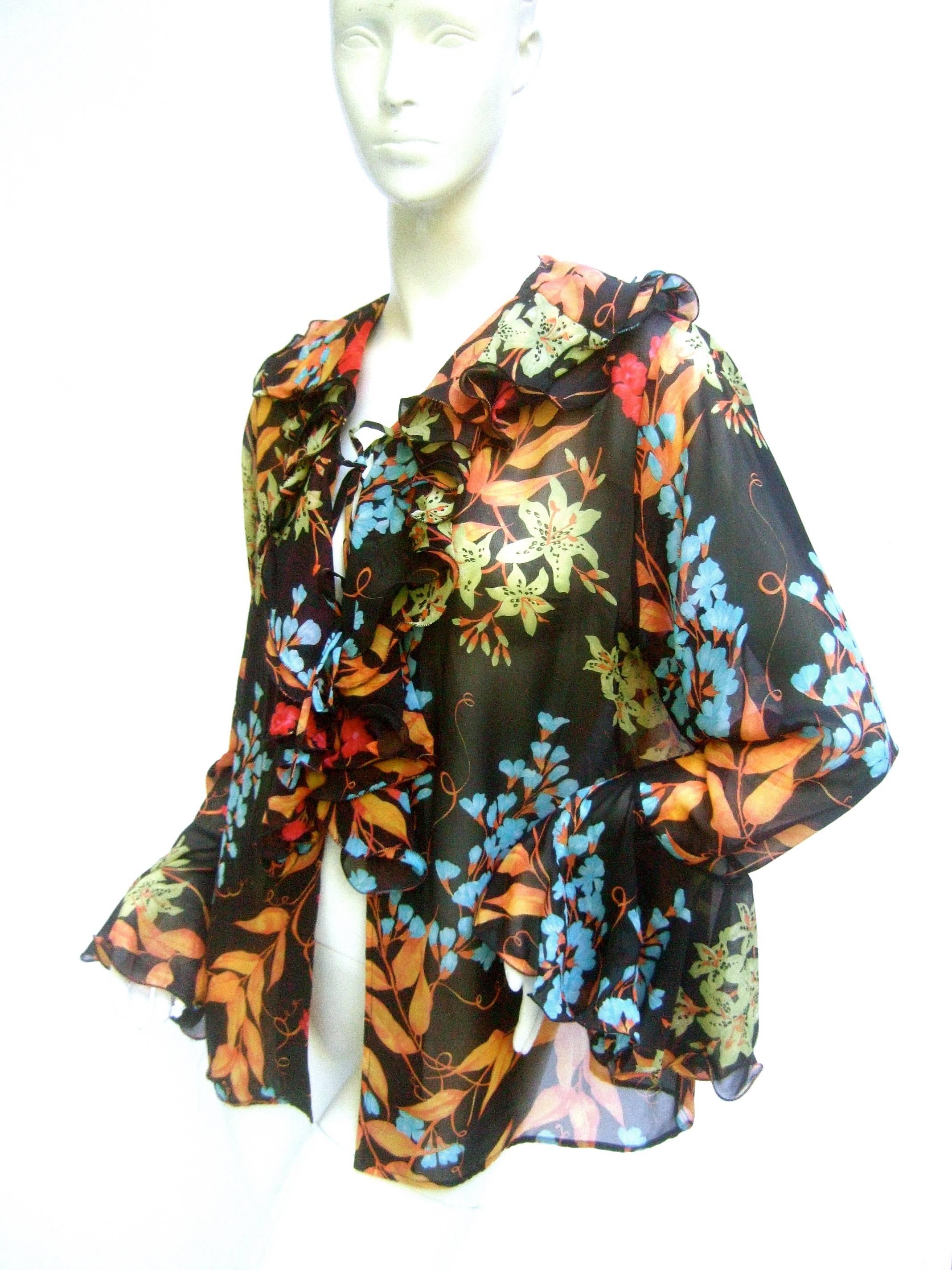 Averardo Bessi Italy Silk floral ruffled blouse 
The sheer black romantic blouse is a garden
of vibrant flower blooms throughout

The loose floaty silk blouse is designed 
with a cascading ruffled collar and billowy
tiered voluminous