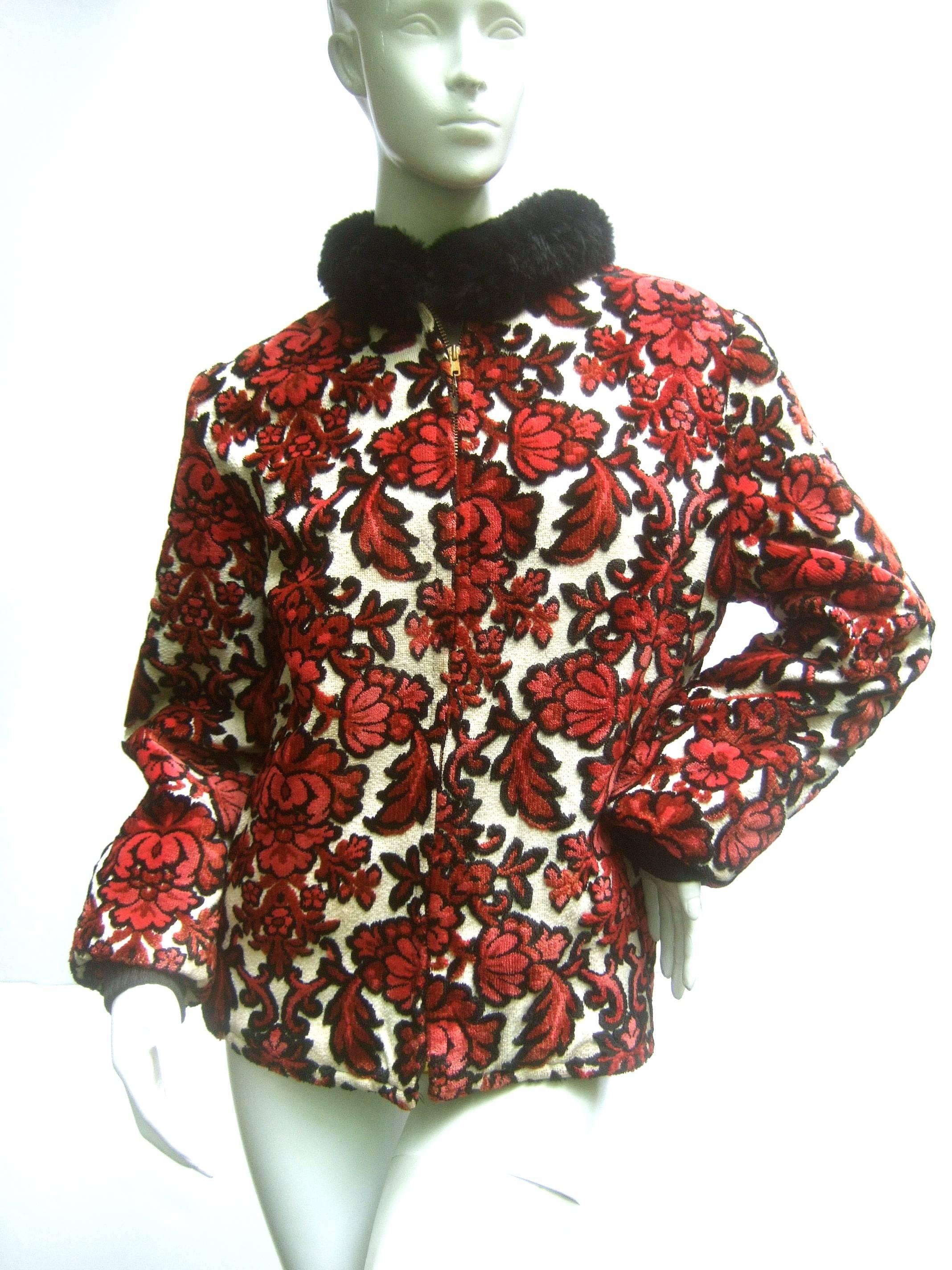 1960s Brocade cut velvet zippered jacket 
The unique retro jacket is a vibrant series
of bold deep red flowers set against 
an ivory background 

The jacket is accented with a plush faux
fur black collar. Zippers down the front
Lined in black