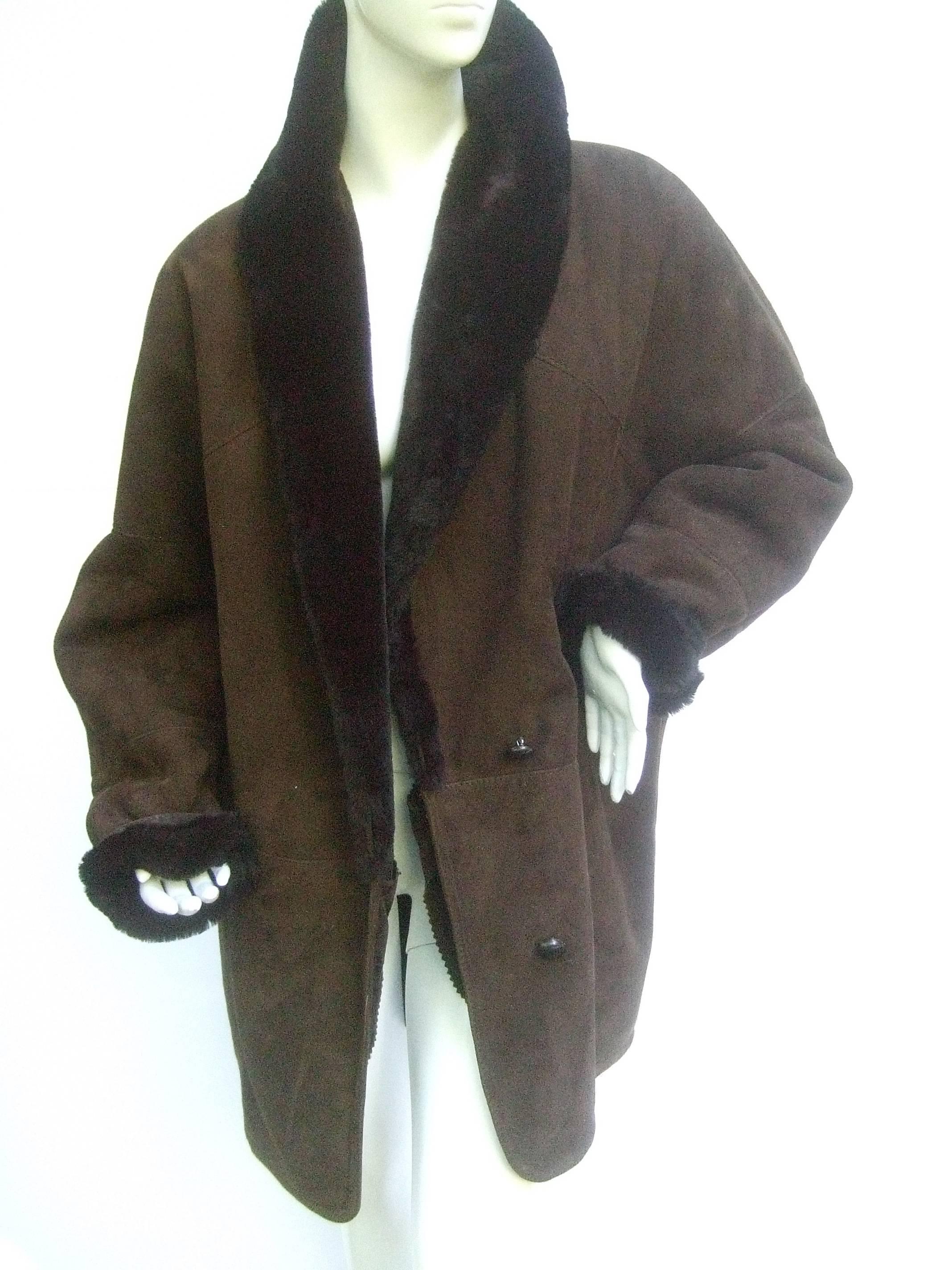 Neiman Marcus Chocolate brown suede shearling jacket 
The stylish winter jacket is designed with a dark brown
suede shell. Lined in plush dark brown faux fur 

The wide voluminous collar can be folded up
around the neckline to ward off cold