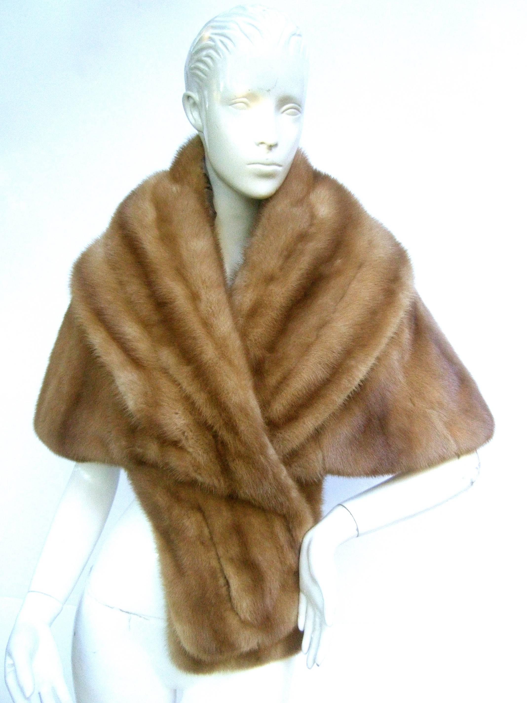 Schiaparelli Rare luxurious autumn haze mink stole c 1960s
The plush light brown mink stole is designed with 
sumptuous fur 

Lined in pewter tone satin illustrated with a collection
of chic midcentury style women in various fashions

Labeled