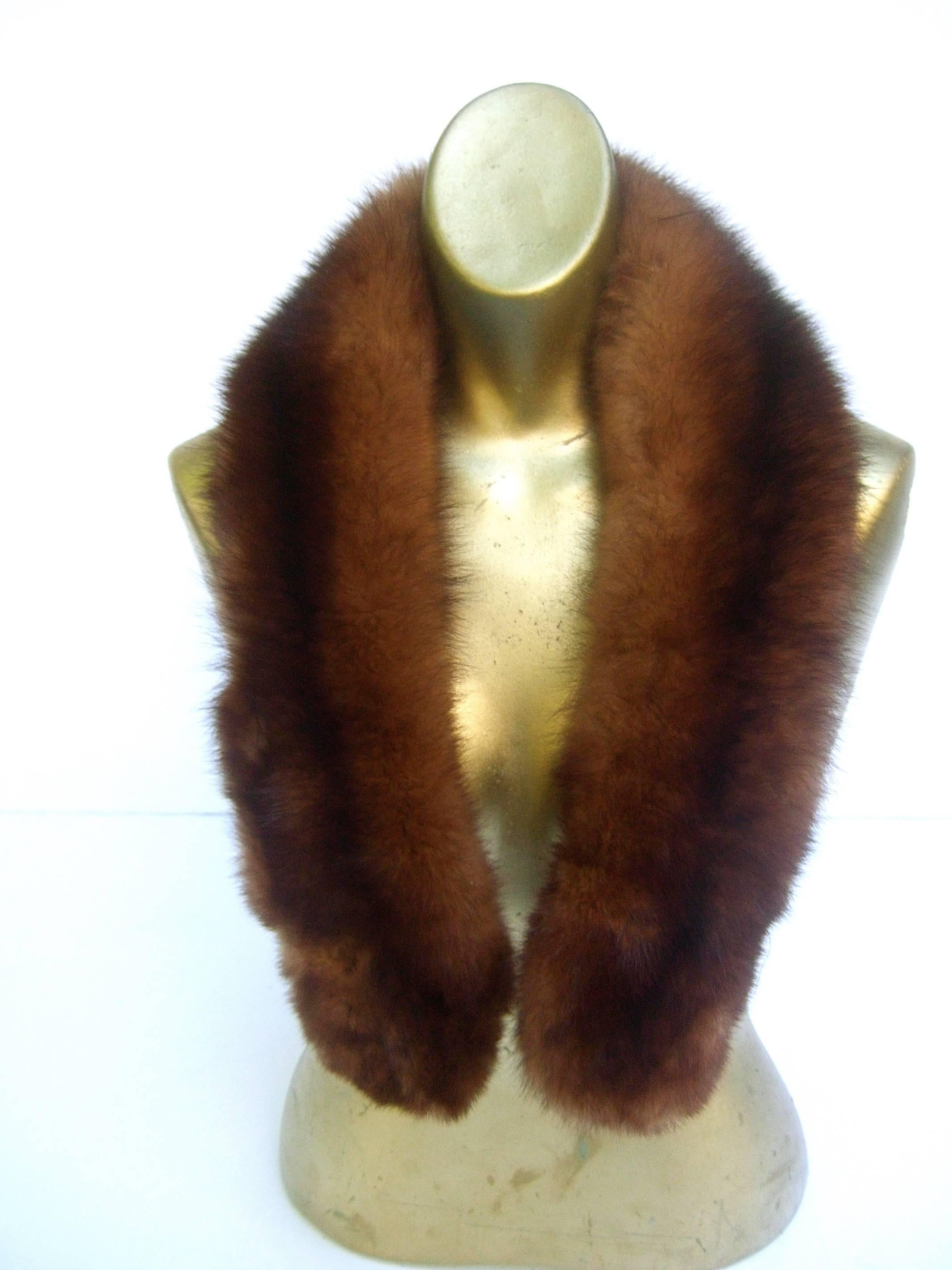 Luxurious plush sable fur collar c 1960
The fluffy mahogany brown sable fur collar
adds a dash of elegance draped over a coat,
 jacket lapel or cardigan

The back side is lined with a black velvet
band designed with a pair of clamps on each