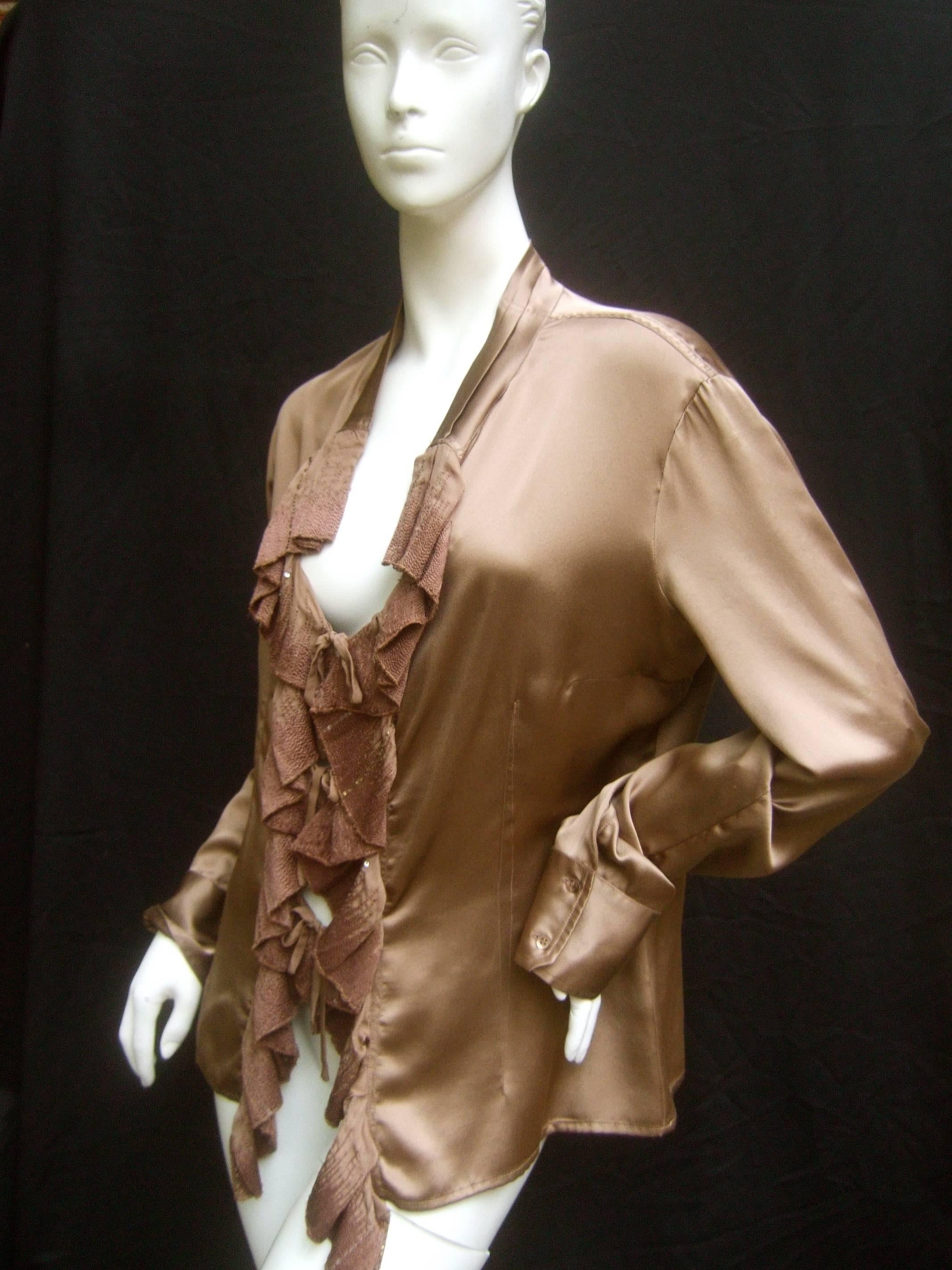 Roberto Cavalli Bronze silk charmeuse ruffled blouse 
The high fashion Italian blouse is designed with luminous 
mocha brown silk

The front is accented with cascading ruffles with
subtle brown embroidery and restrained sequins
The loose
