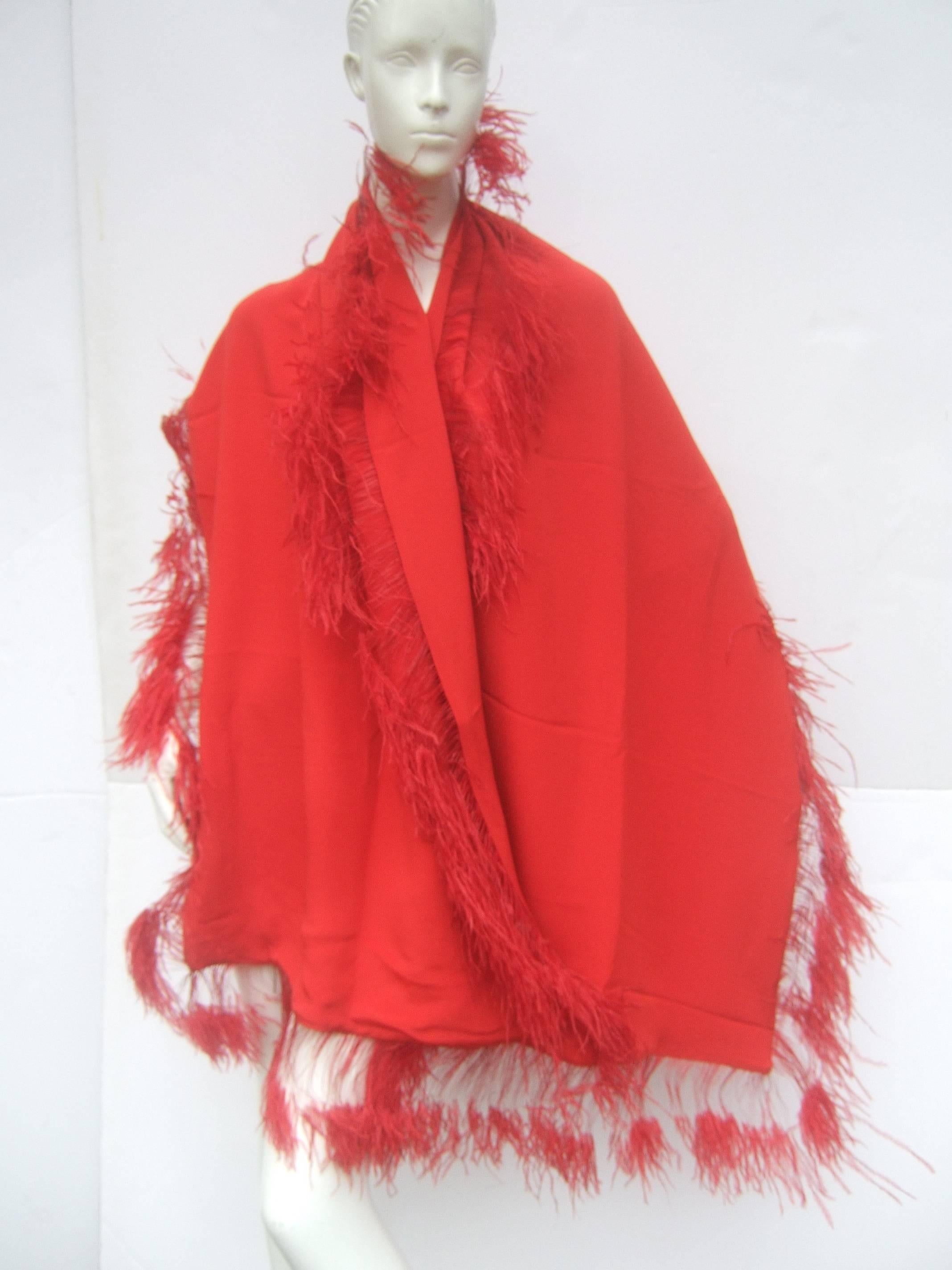 Neiman Marcus Scarlet feather trim shawl 
The stylish dramatic wrap is designed with
double faced silk

The feather trim frames the oblong shawl 
The exotic feather detail makes a chic 
bold accessory 

Perfect for the holidays or special