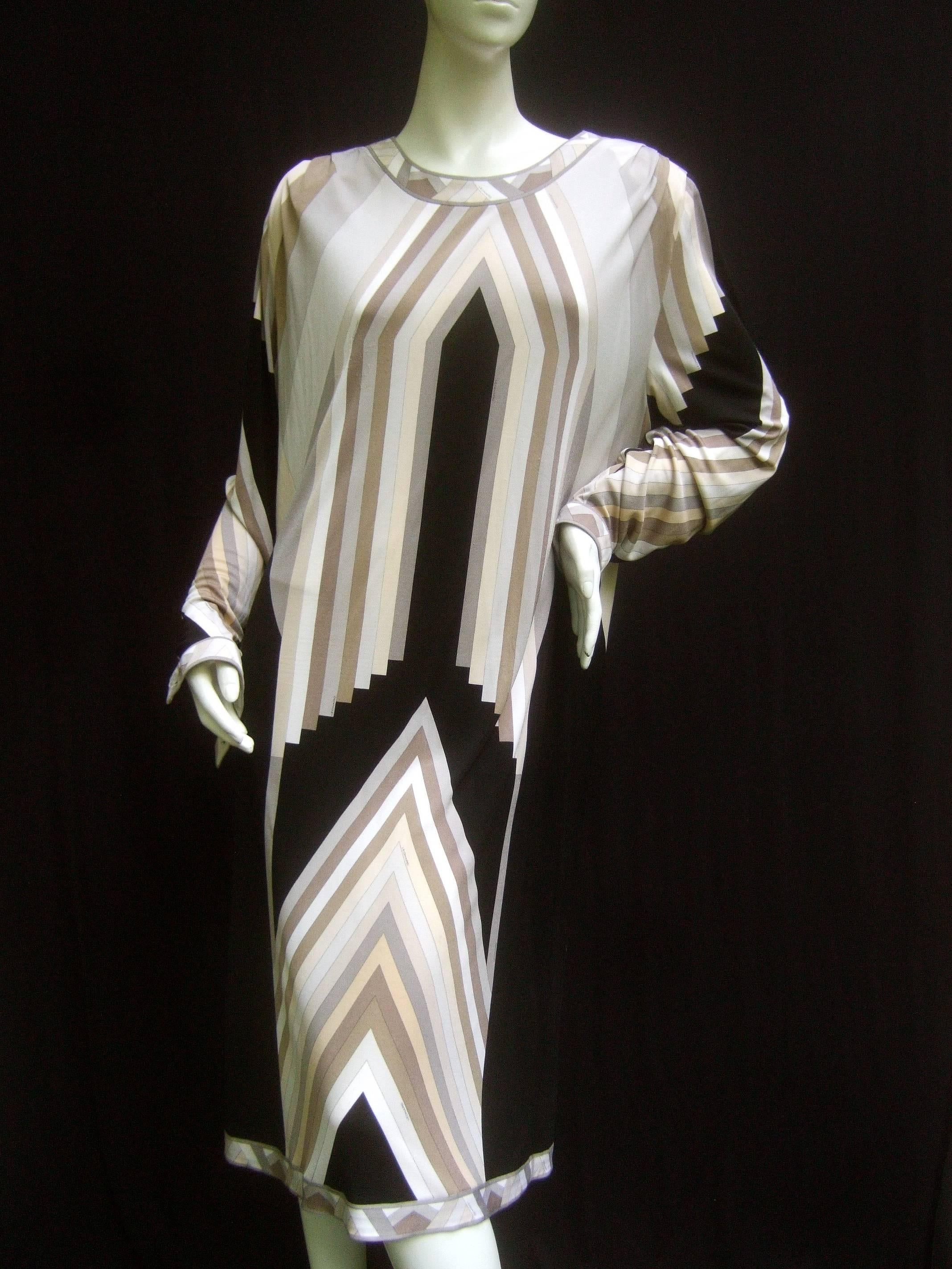 Leonard Paris Silk jersey architectural print dress c 1990   
The elegant dress is illustrated with vertical linear 
bands in subdued hues of ivory, cream, mocha 
browns, light smoky grays illuminated against 
solid black color block silk jersey