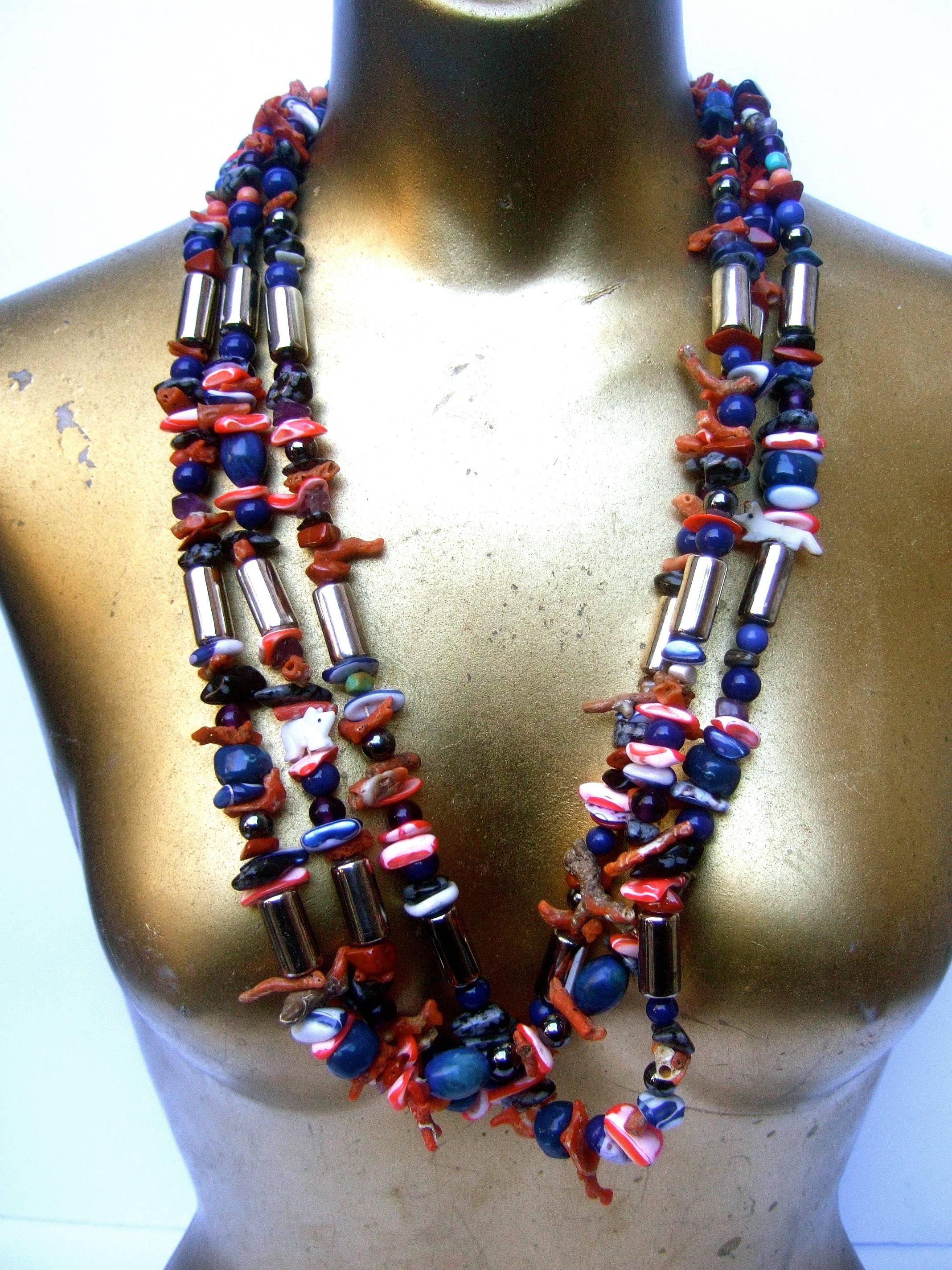 Exotic artisan coral & lapis statement necklace
The unique handmade artisan necklace is a collection
of semi precious smooth & jagged beads & stones

The myriad of semi precious embellishments consists 
of lapis, coral, agate, amethyst, hematite &