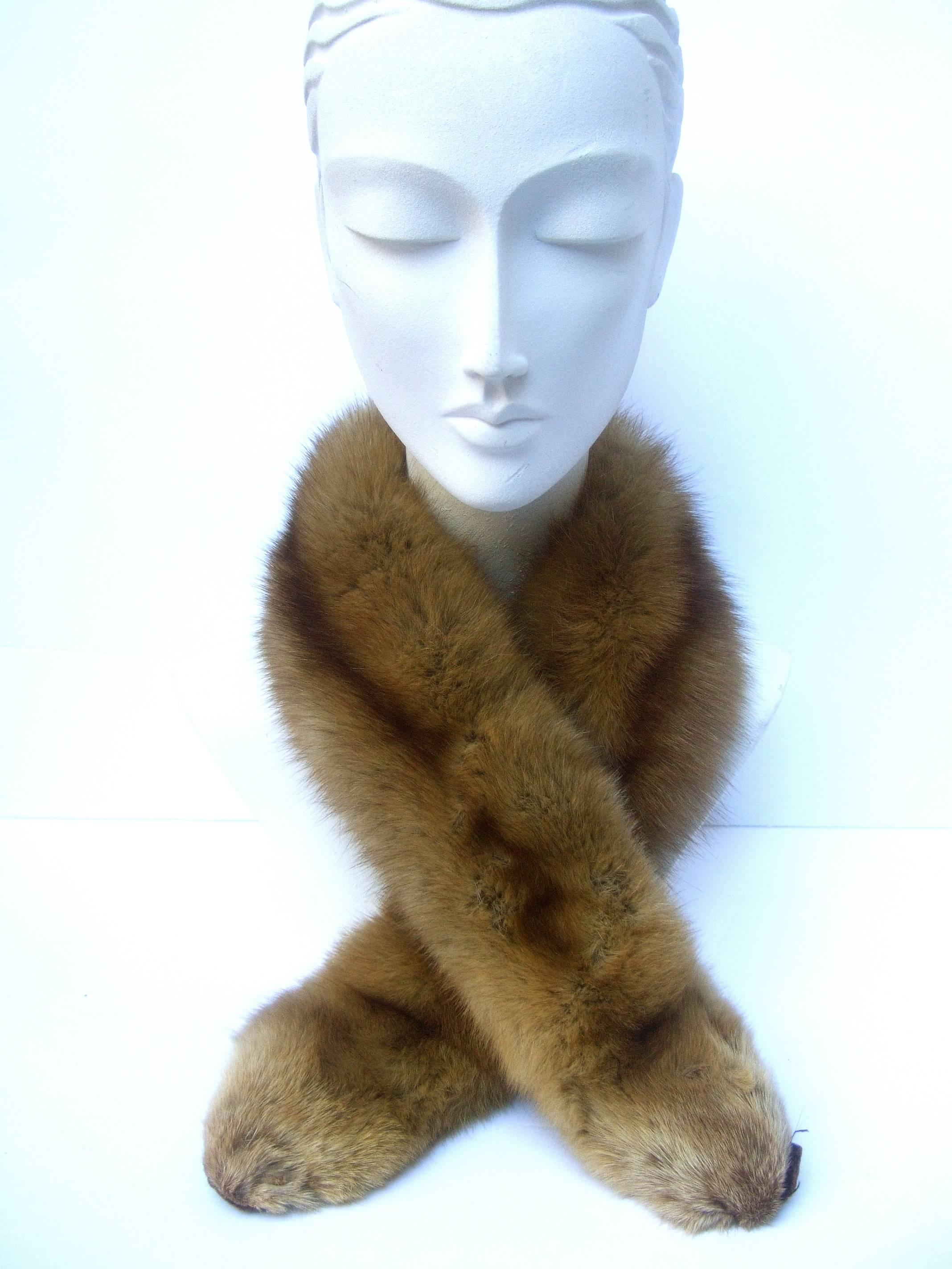 Luxurious plush sable fur collar ca 1960s
The elegant sable fur is light & fluffy
Running down the center is a darker 
brown streak of sable fur 

Makes an elegant accessory wrapped 
around the neck or draped over the
shoulder lapels  

Lined in