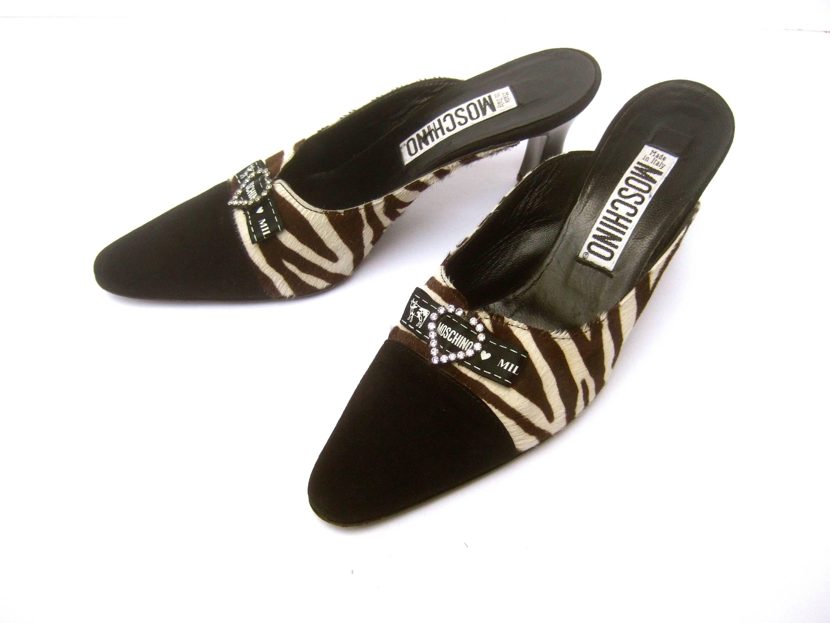***RESERVED SALE PENDING FOR MONIQUE***
Moschino Italy Zebra print pony hair mules Size 37 or US Size 6.5
The stylish Italian shoes are designed 
with brown and cream zebra print pony fur

The pointed toes are covered with black suede
The front of