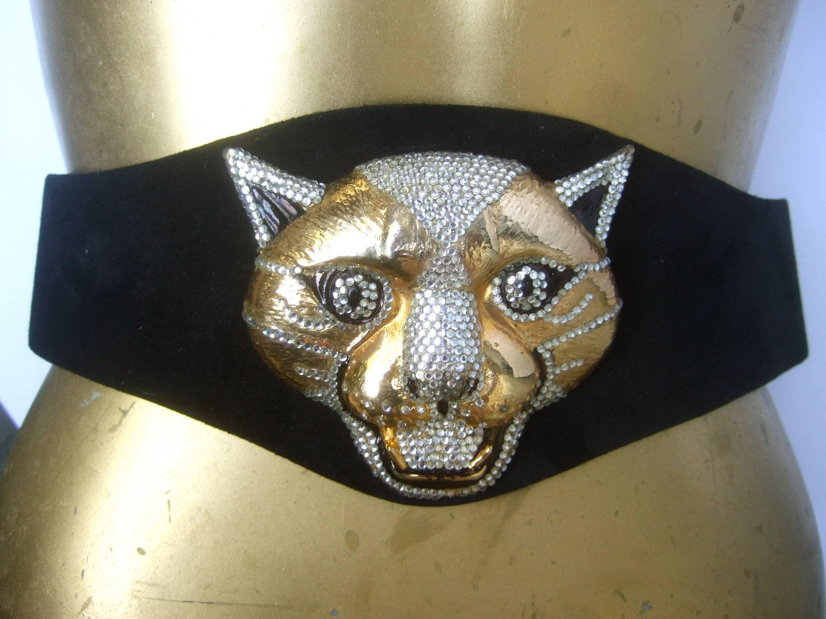 Spectacular massive jeweled suede panther buckle belt c 1970
The incredible belt is adorned with a huge gilt metal 
panther's head encrusted with glittering diamante crystals 

The panther's face is accented with black enamel 
and exposed