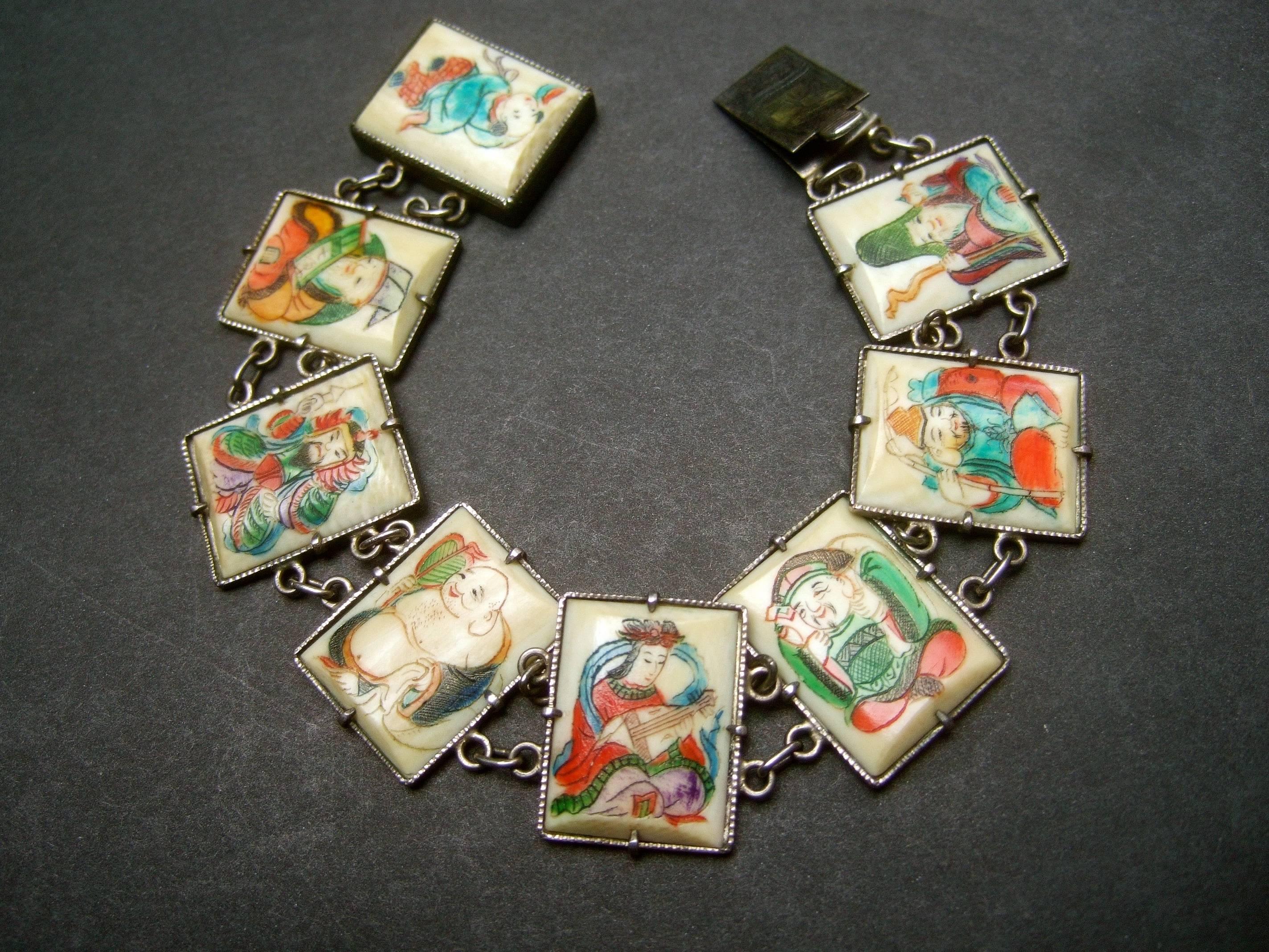 Exotic Chinese Eight immortals sterling link bracelet ca 1930s
The rare artisan bracelet is designed with thin bone 
veneer hand painted tiles set in sterling bezel links 

The eight immortals derive from Chinese mythology  
possessing the powers of