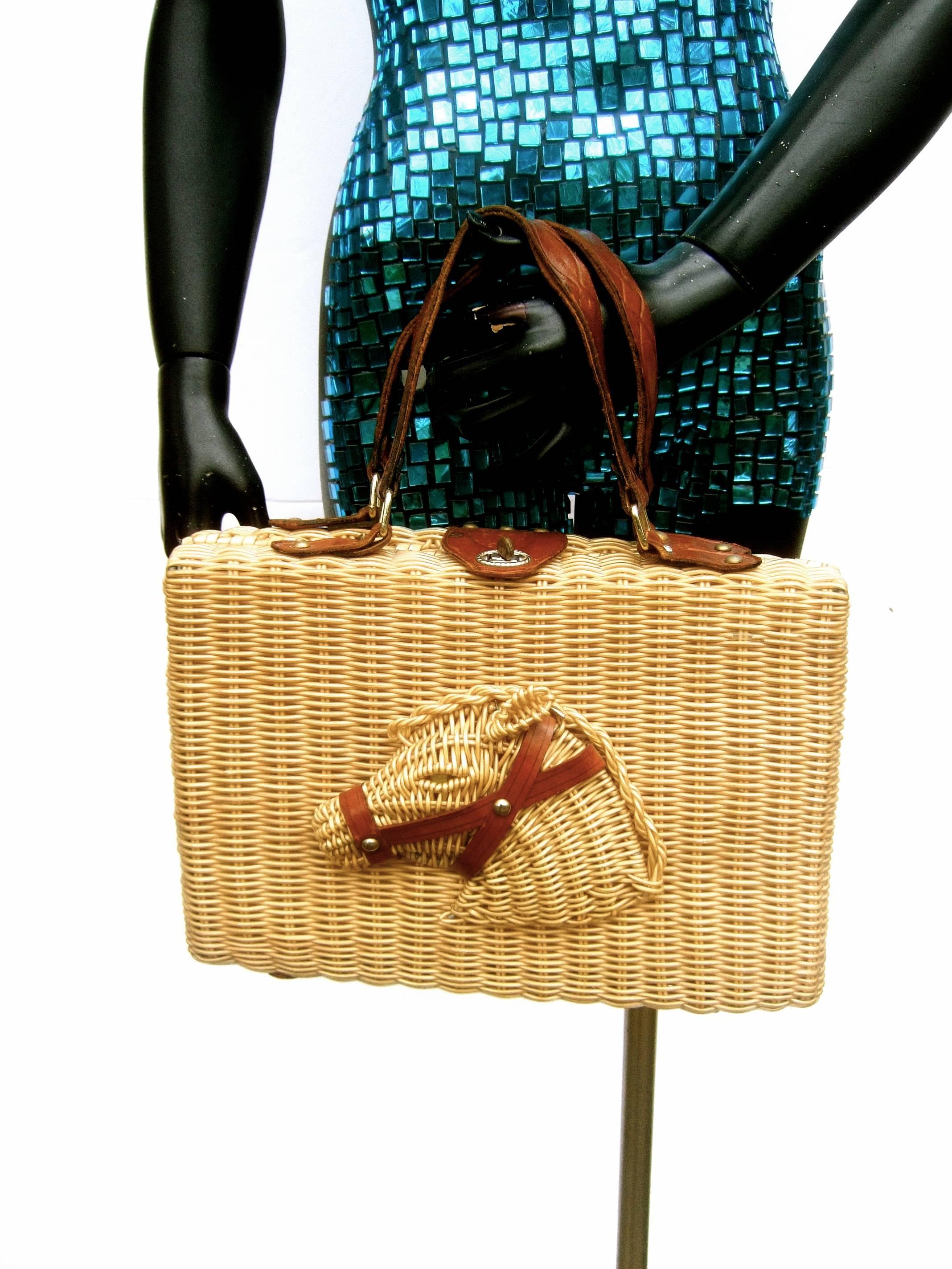 Unique wicker horse head leather trim handbag ca 1960s 
The vintage wicker handbag is designed with a 
three dimensional horse head on the front panel 

The horse head is designed with brown leather 
bridal straps and a glass marble eye

Carried