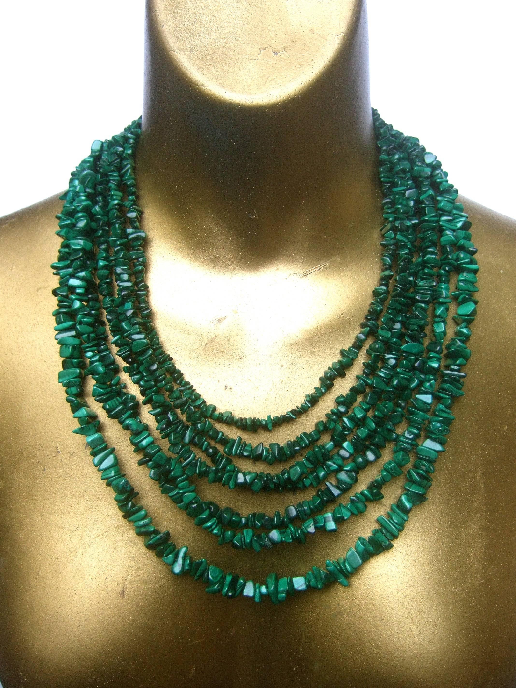 Malachite graduated nugget artisan necklace
The bold statement necklace is designed with
seven graduated strands of enhanced malachite 
nuggets

Makes a dramatic accessory that transitions
effortlessly from casual to formal wear

The strands of