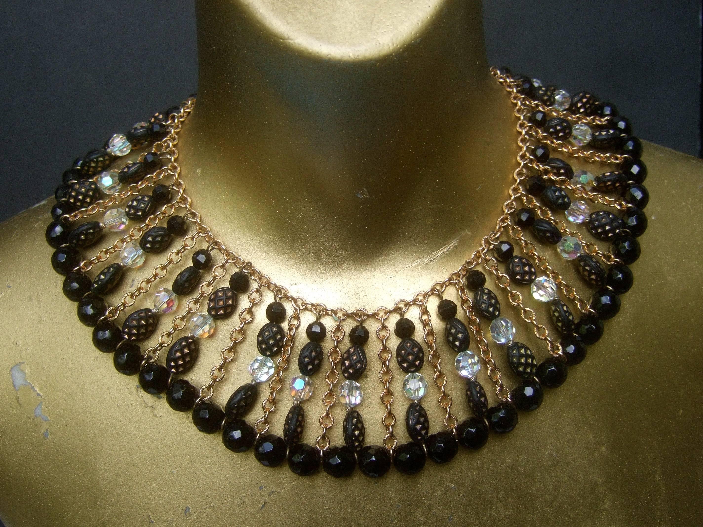 Trifari Exquisite crystal beaded parure necklace set ca 1960s 
The elegant set is designed with a jet black 
and aurora borealis faceted crystal beads combined
with textured black and gold resin beads 

The dramatic crystal beaded collar necklace