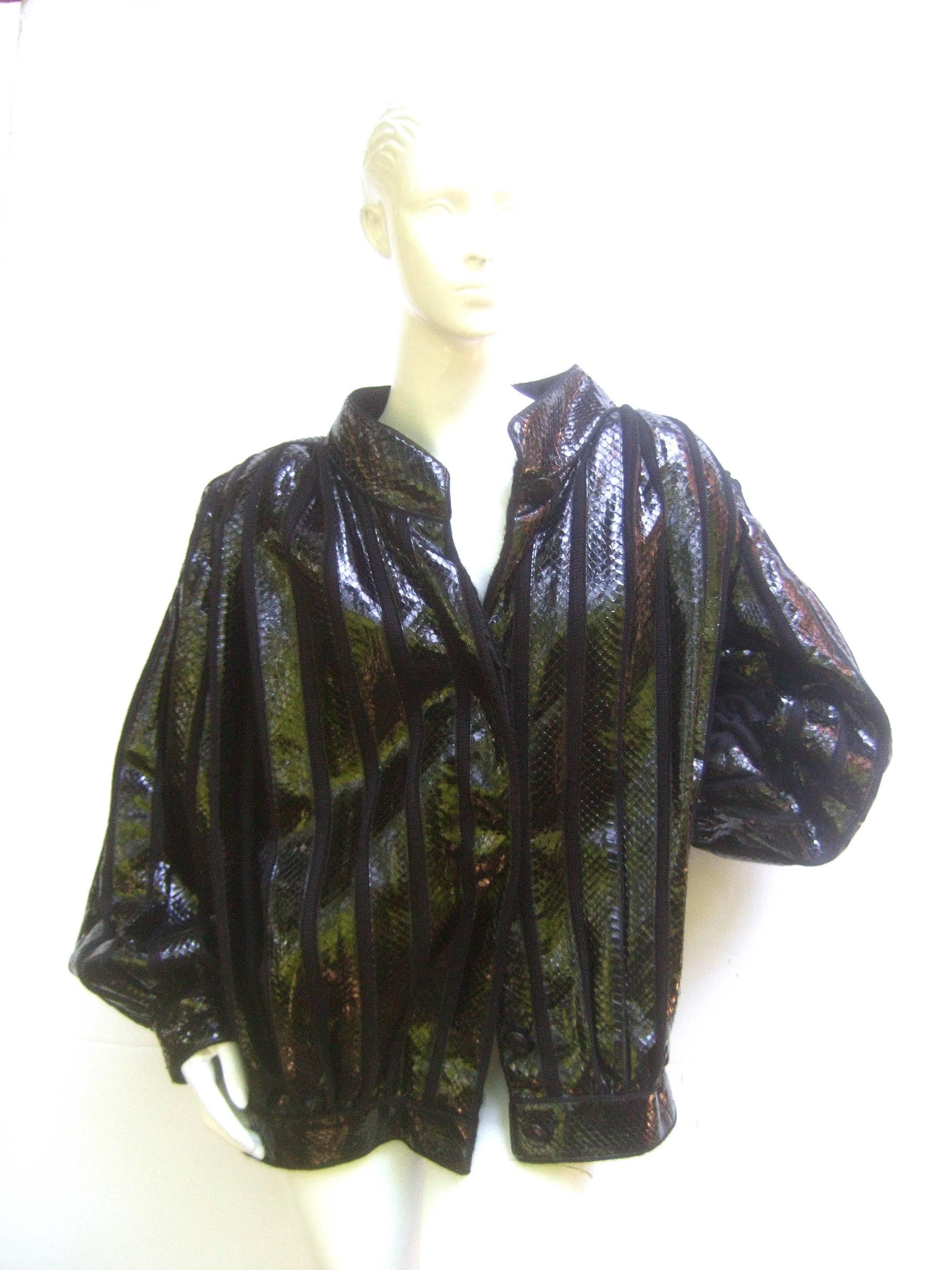 Avant garde Italian snakeskin jacket from Neiman Marcus Size 44
The exotic 1980s Italian voluminous boxy jacket is designed with 
vertical bands of shiny black snakeskin. Underneath the snakeskin 
bands is a black mohair shell that is partially