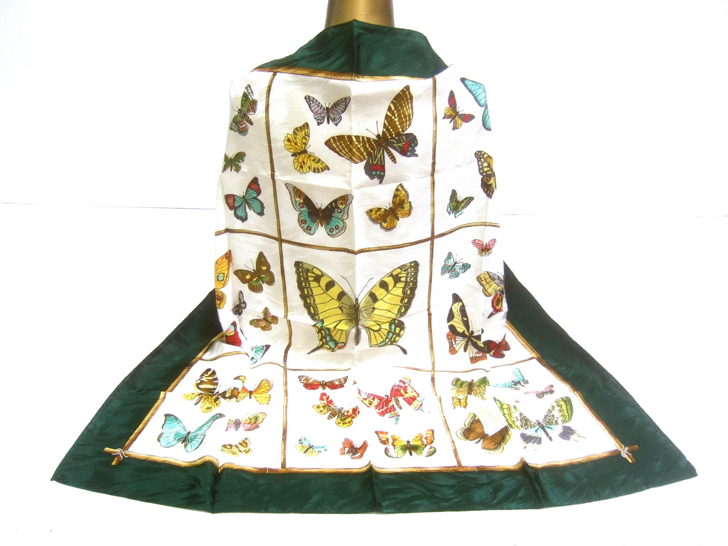 Italian luxurious silk hand rolled butterfly scarf ca 1990 
The elegant silk scarf is illustrated with a collection
of various species of butterflies 

The fluttering butteries are illuminated against 
an ivory silk background. The borders are