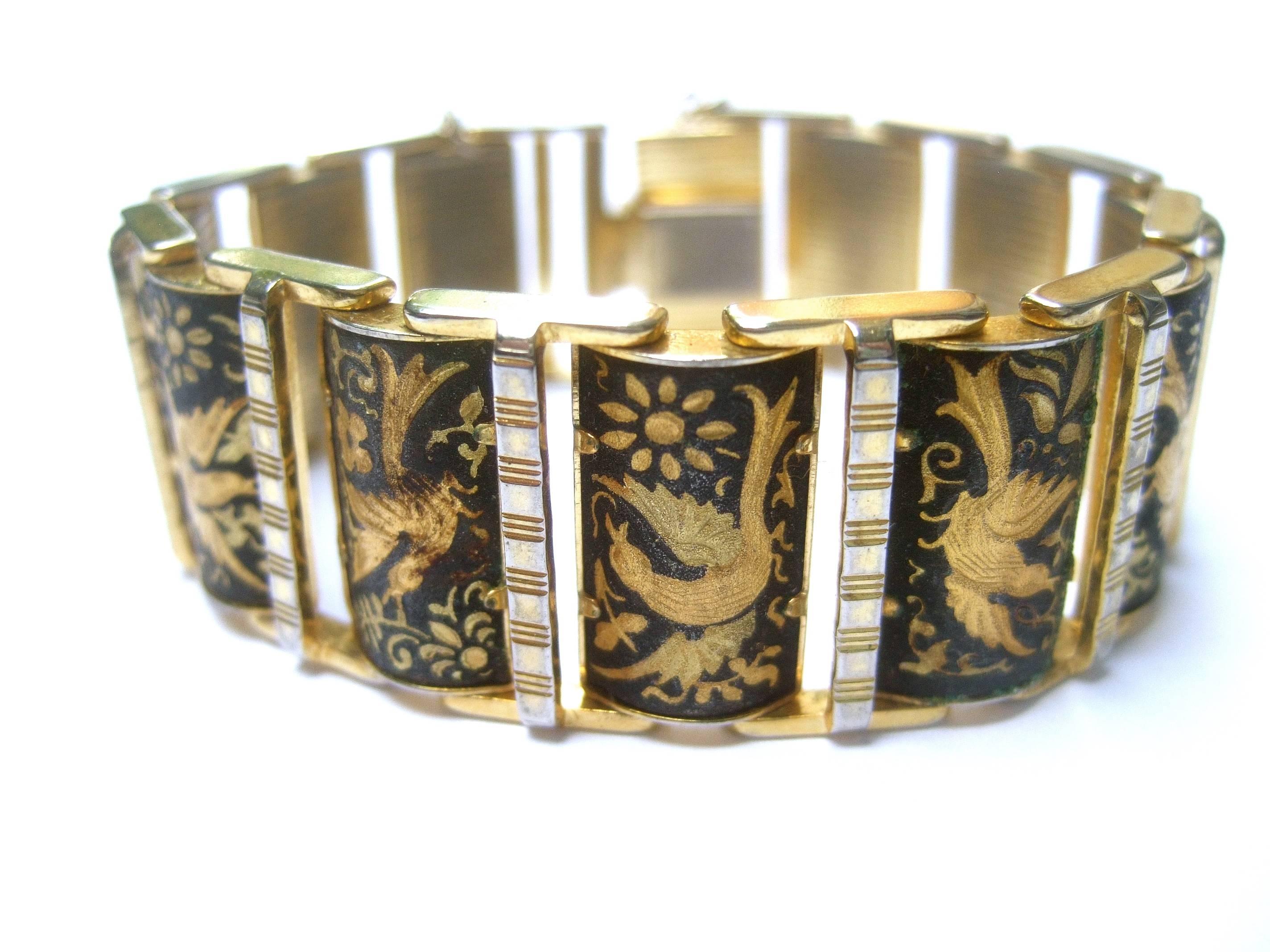 Exquisite etched gilt metal bird theme link bracelet ca 1960
The elegant retro bracelet is designed with a series 
of hinged links

Each link depicts a majestic bird in various postures
The collection of birds have intricate etched detail 
that