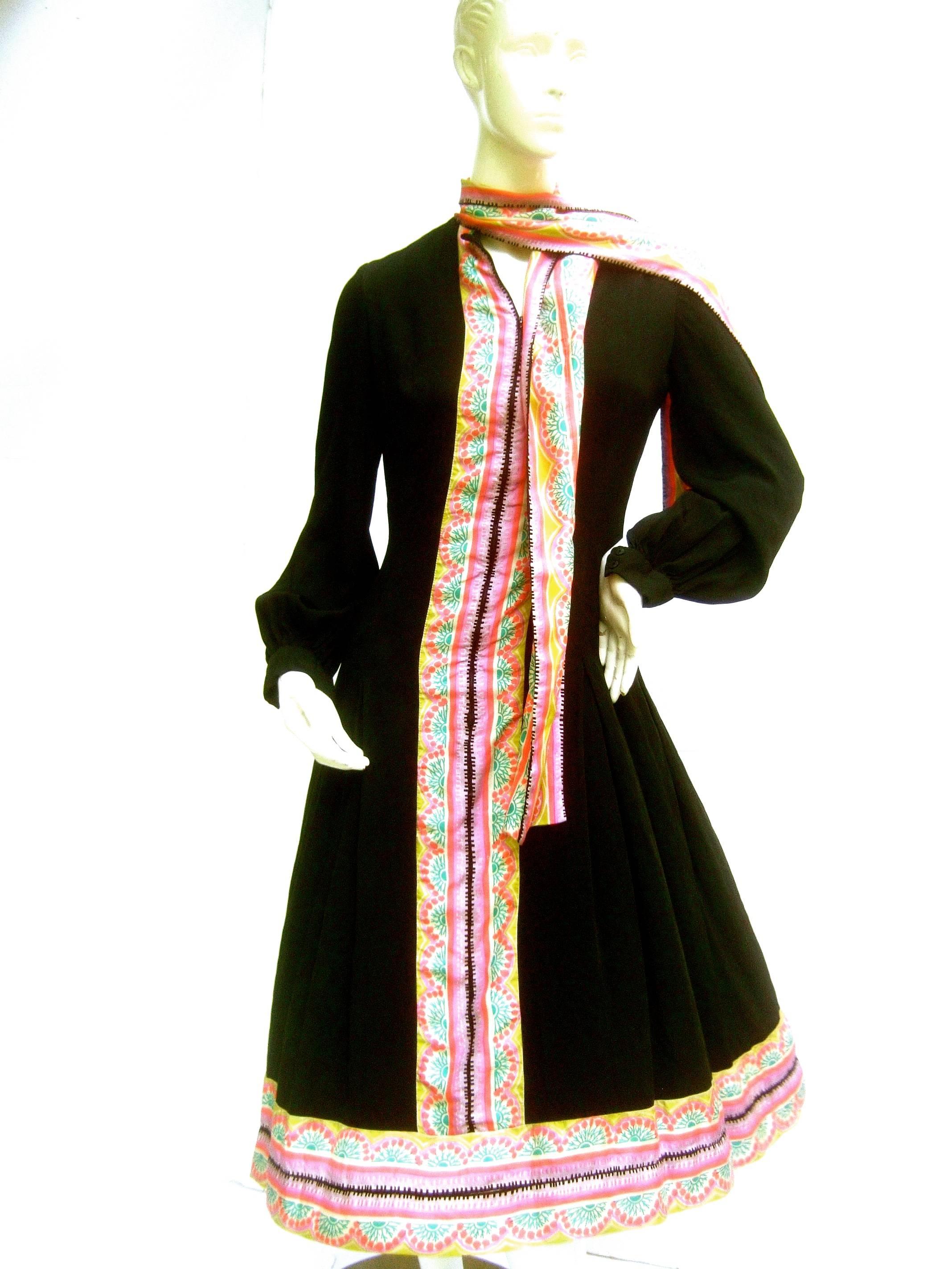 Chester Weinberg Innovative black silk pastel trim dress c 1970
The stark black silk crepe dress is illuminated with vibrant
pastel silk trim that runs down the front and circles the
hemline 

The collar is designed with a dramatic stationary silk