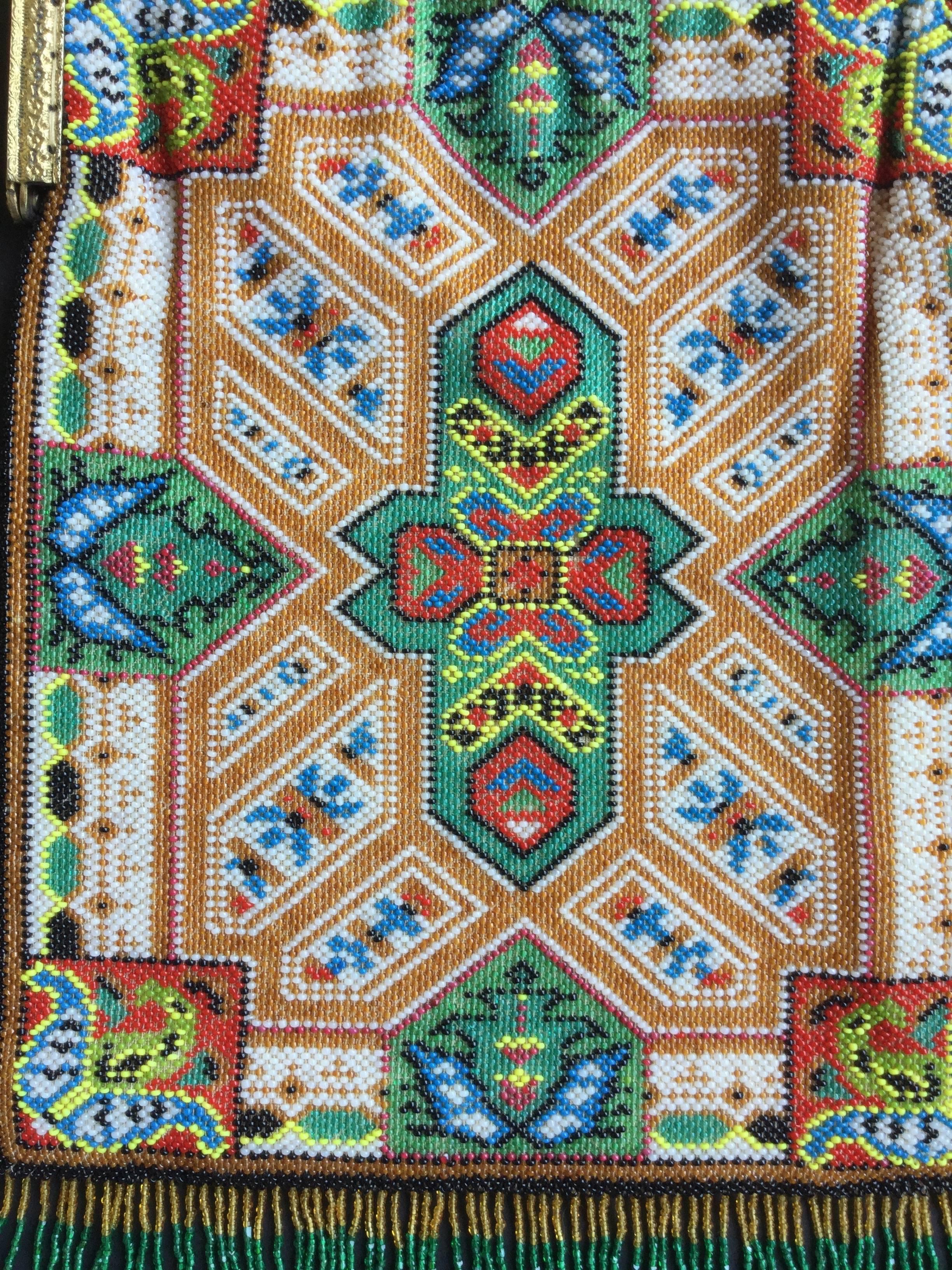 Rare and striking fringed Victorian beaded bag depicting an oriental rug. The detail here is just extraordinary. Thousands upon thousands of tiny glass seed beads have been hand-woven to create this exquisite work of domestic art. The design is the