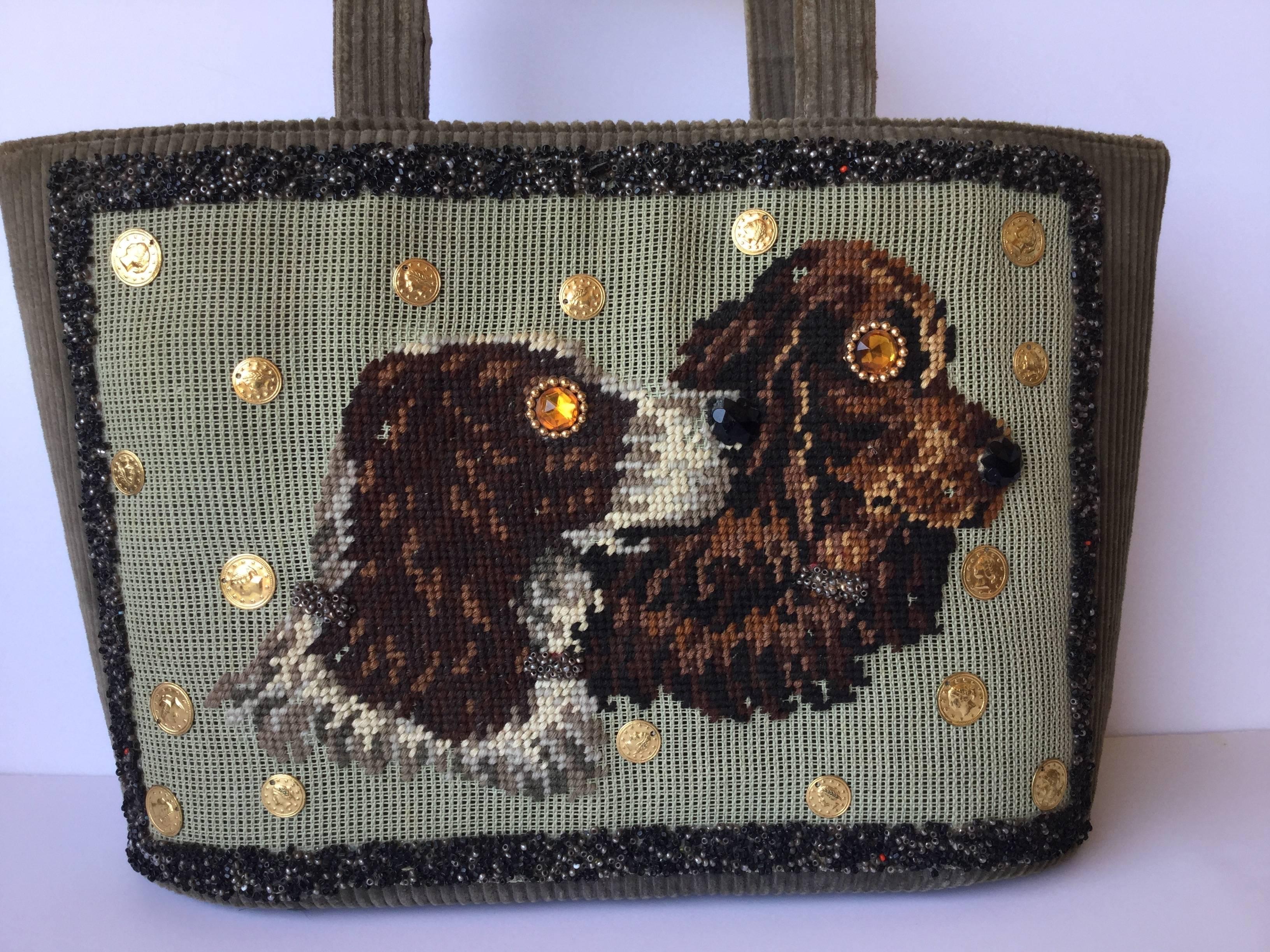 This is simply to coolest dog themed bag I have seen in ages!  Made of rich, olive green, wide wale corduroy which hosts an extraordinary panel of hand sewn needlepoint depicting two Spaniels. These canines are quite mesmerizing
with their eyes all