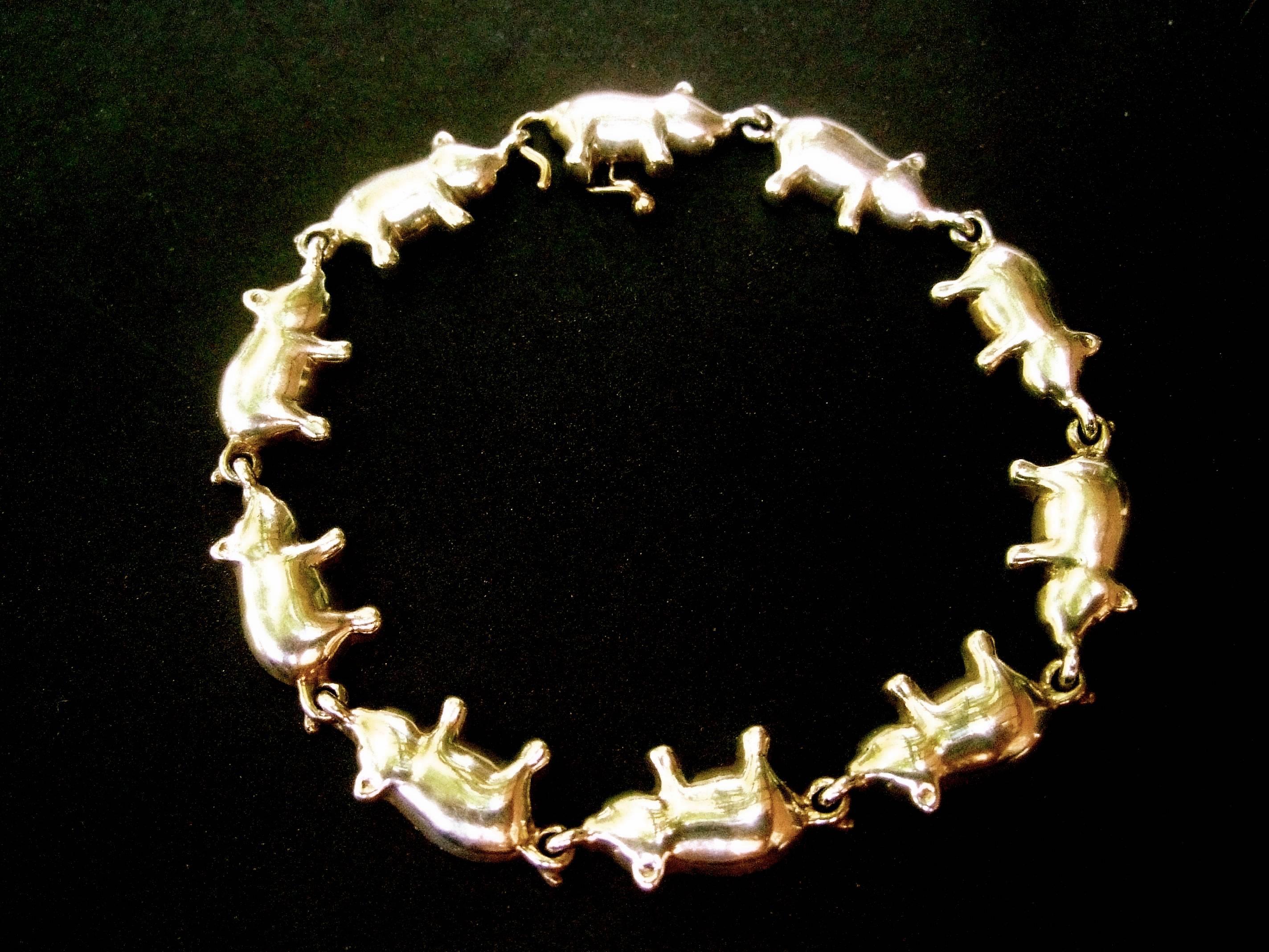 Whimsical sterling silver pig theme link bracelet 
The adorable series of pigs are hinged together 
by their curled tails 

Makes a charming fun accessory 

Measurements 
The series of hinged pigs measures 7.5 inches in length
The pig figures