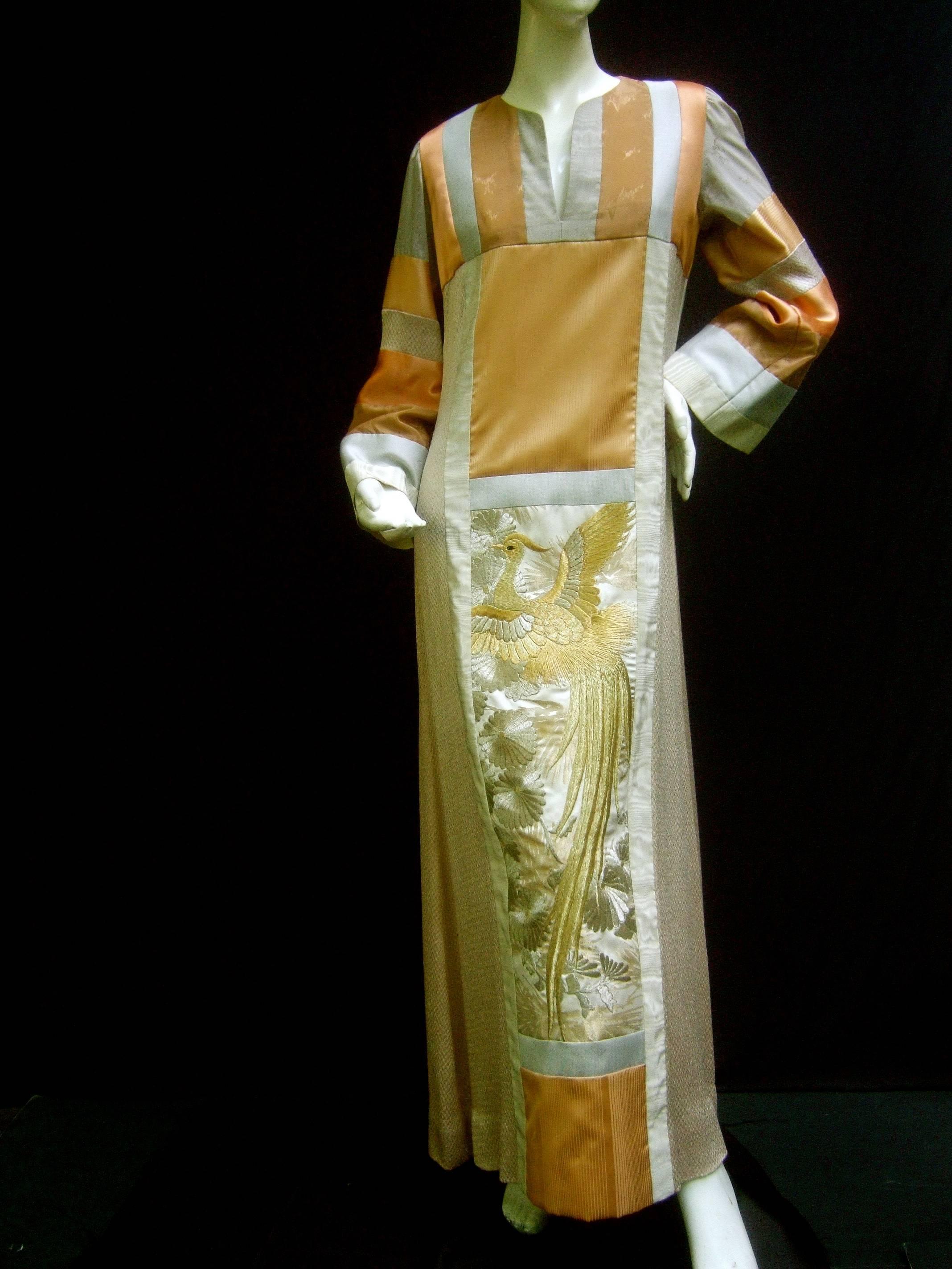 Stunning rare Japanese style caftan gown by Jon Shannon c 1970s
The opulent caftan is designed with color block panels 
in soothing earth tone hues 

The lower front section is embellished with an elaborate exotic
bird in gold metallic thread;