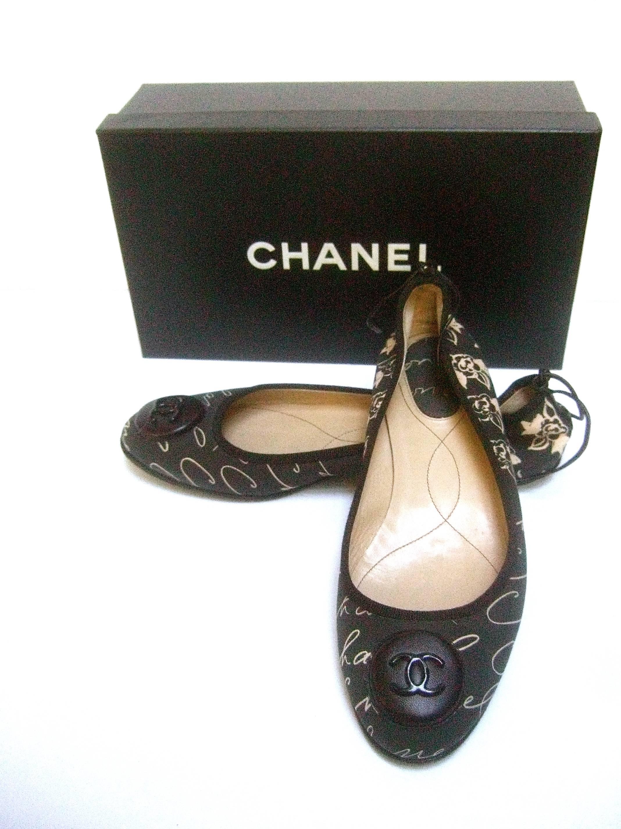 Chanel Iconic Italian ballet style flats in Chanel box Size 38.5
The stylish skimmer flats are adorned with Chanel's 
C.C. initials on the front of each shoe 

The sides are covered in cloth with Chanel's 
script name repeated throughout and her