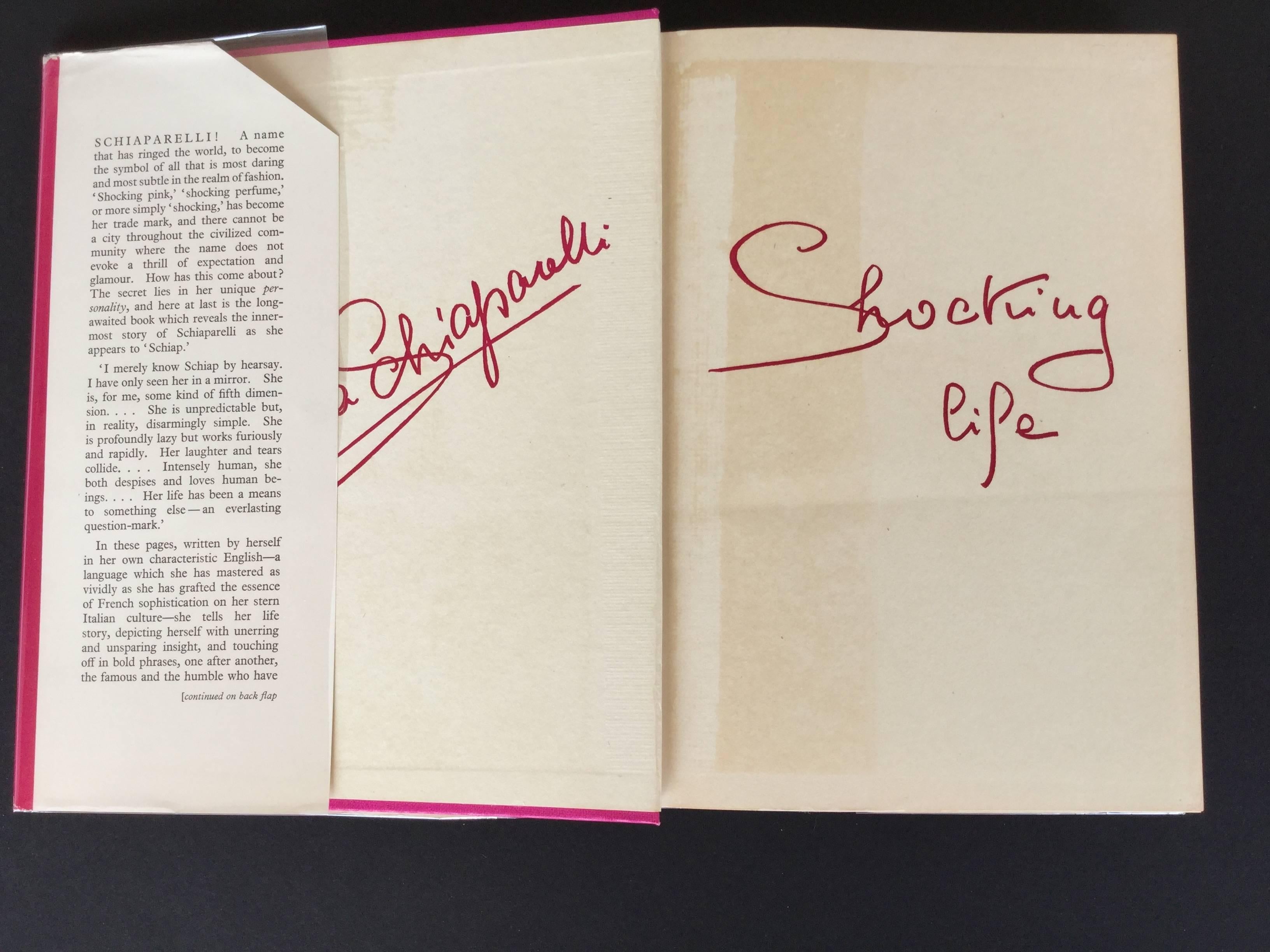 British 1st Edition of Elsa Schiaparelli's fascinating autobiography A Shocking Life. Original pink dust cover protected by (removable) clear plastic sleeve. Contains 30 illustrations; 4 color and 26 black and whites. Personally I have always