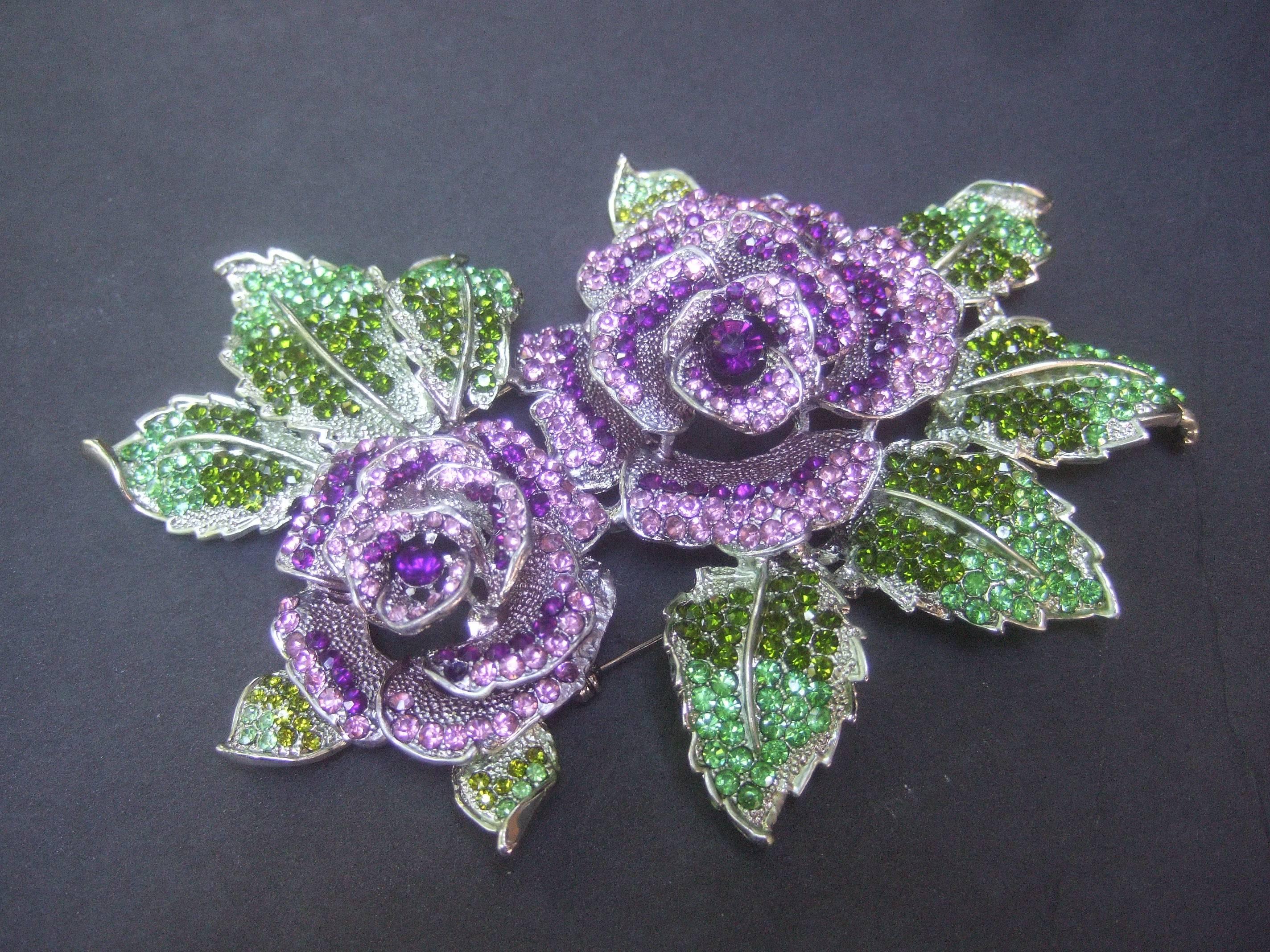 Stunning massive glittering crystal rose theme brooch 
The huge scale brooch is designed with a pair of three
dimensional crystal rose buds in pastel hues
of lavender and amethyst color glass 

The edges of the brooch are designed with