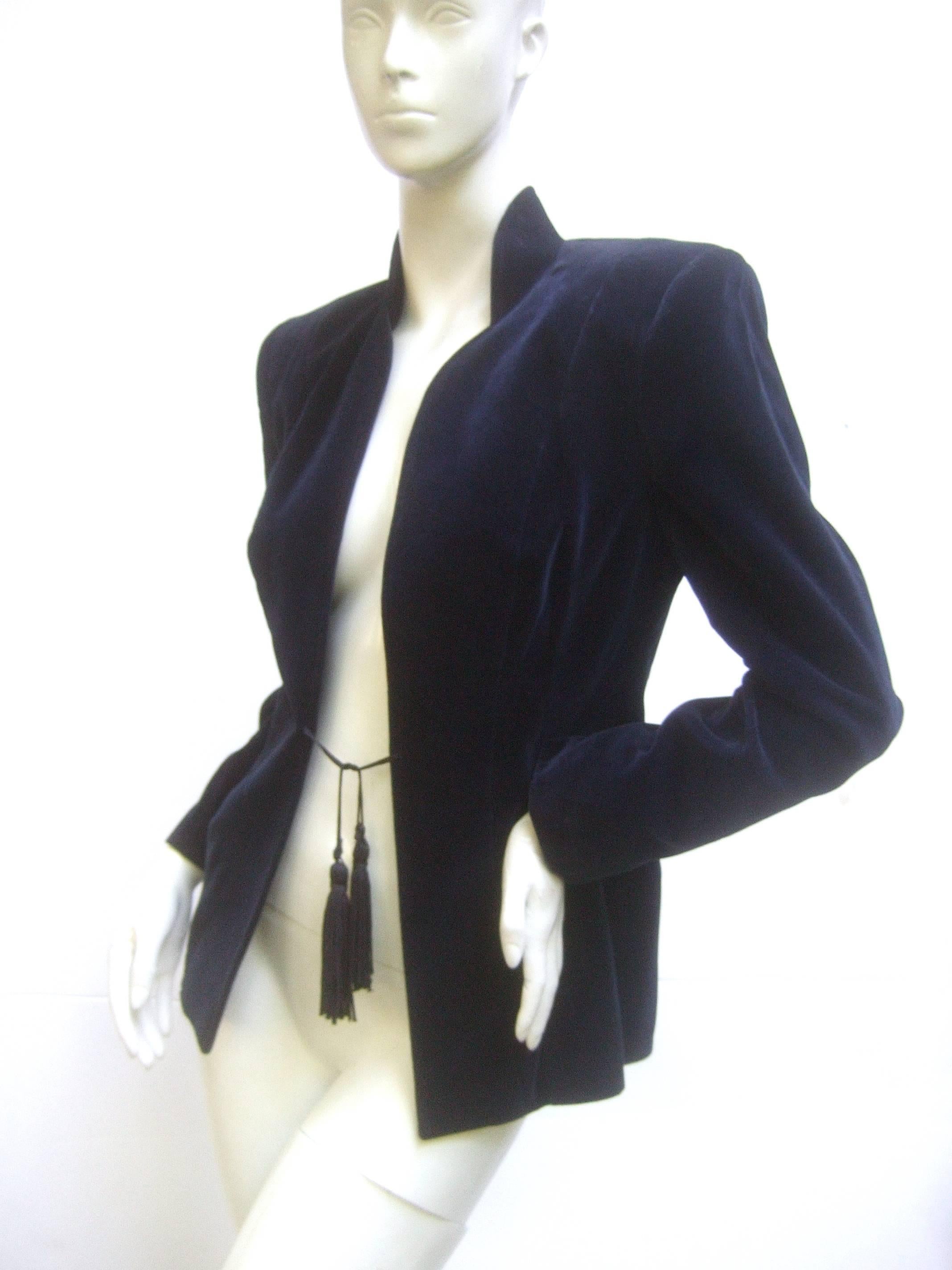 Gorgeous Ossie Clark rich midnight blue velvet jacket from the early 1970's. No doubt a nod to the YSL velvet jackets that were coming out of Paris at this time but with a softer Asian inspired feel conveyed by the black tassel closure and the