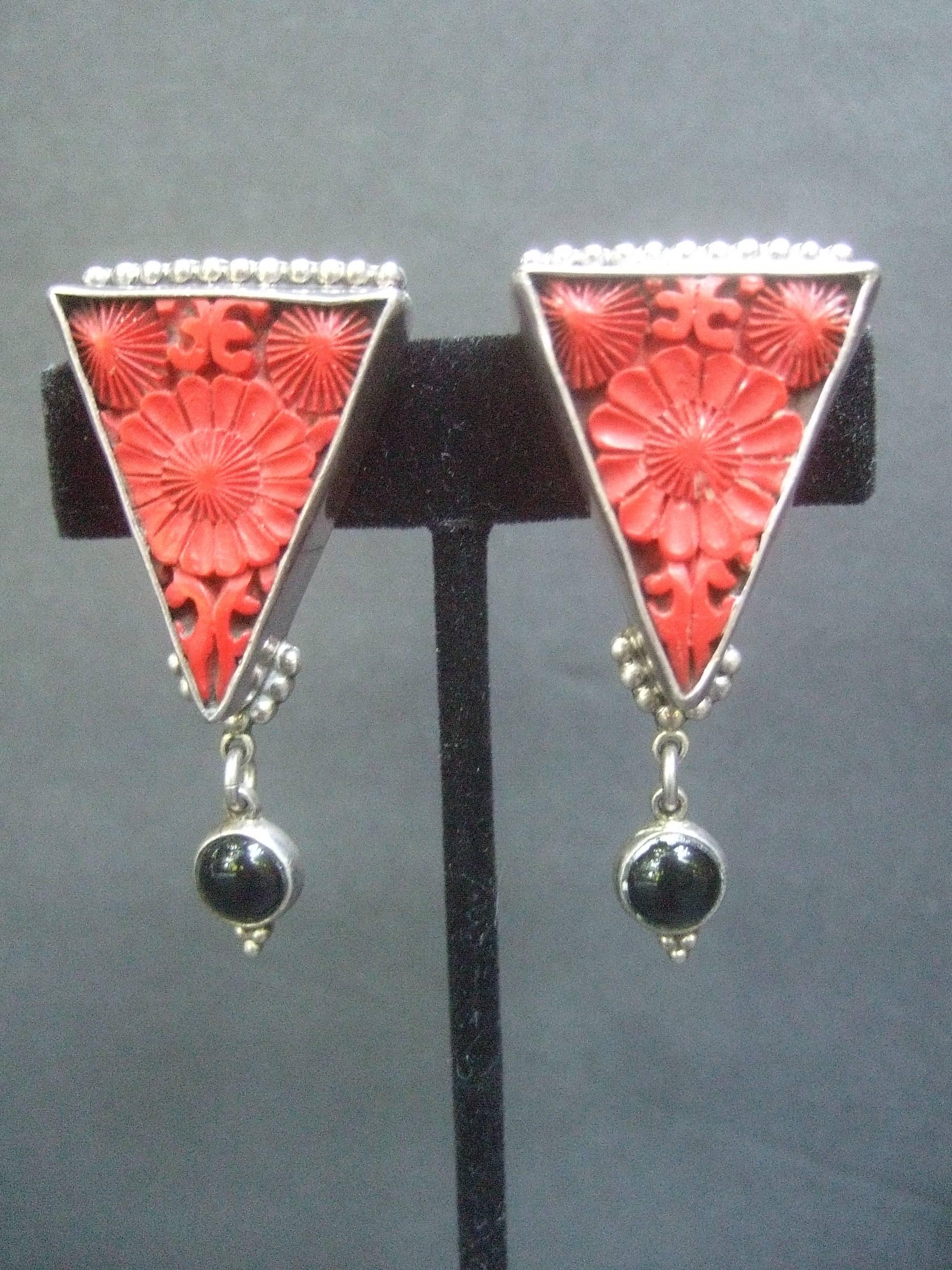 Rare carved coral and jet sterling artisan earrings 
The handmade artisan clip on earrings are designed
with intricately carved coral inset tiles with floral motifs 

Dangling from the triangular sterling bezels 
are small smooth round jet glass