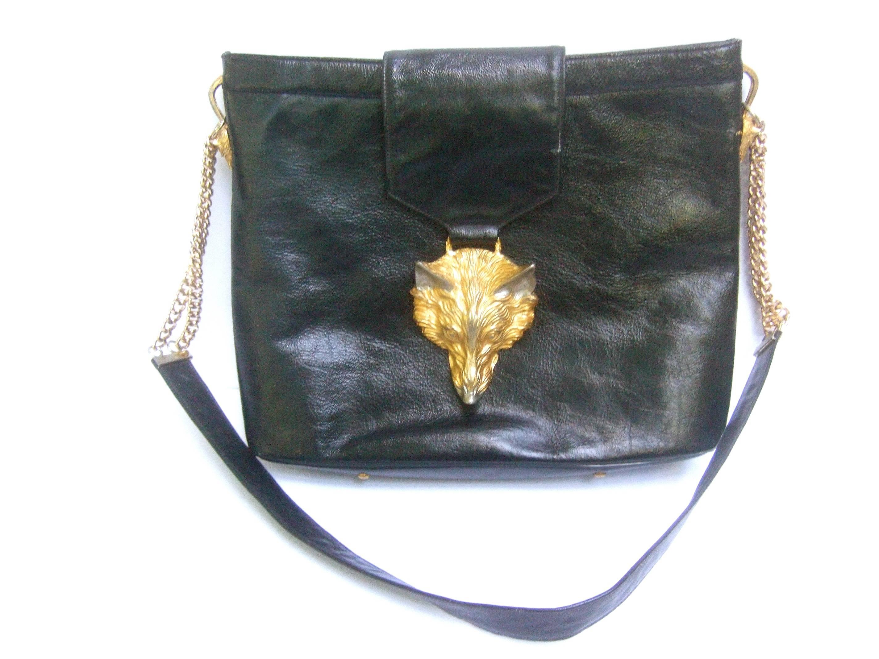 Avant Garde fox emblem leather handbag designed by Harry Rosenfeld 
The stylish black leather shoulder bag is adorned with a large
scale gilt metal fox head. Accented with etched detail that emulates fur
The tip of the nose and ears are juxtaposed