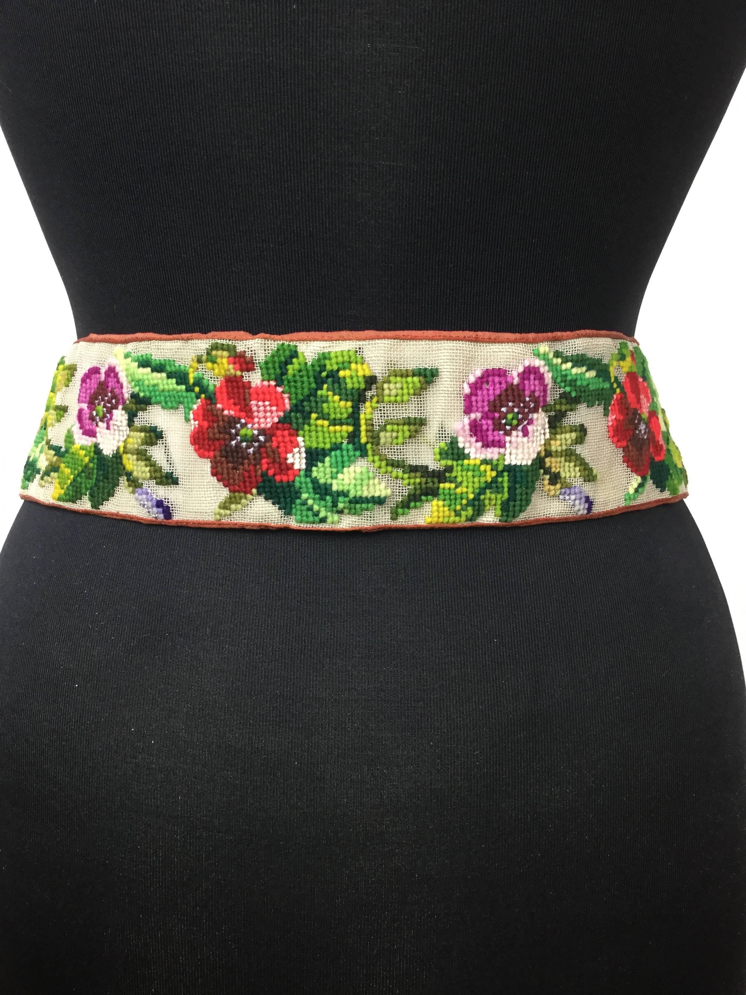 This super rare hand made Victorian needlepoint belt features a garden of Berlin Wool Work floral embroideries.  The colors are incredibly rich and vibrant for a piece of this age. It closes with an anchor themed gold plated metal buckle. The