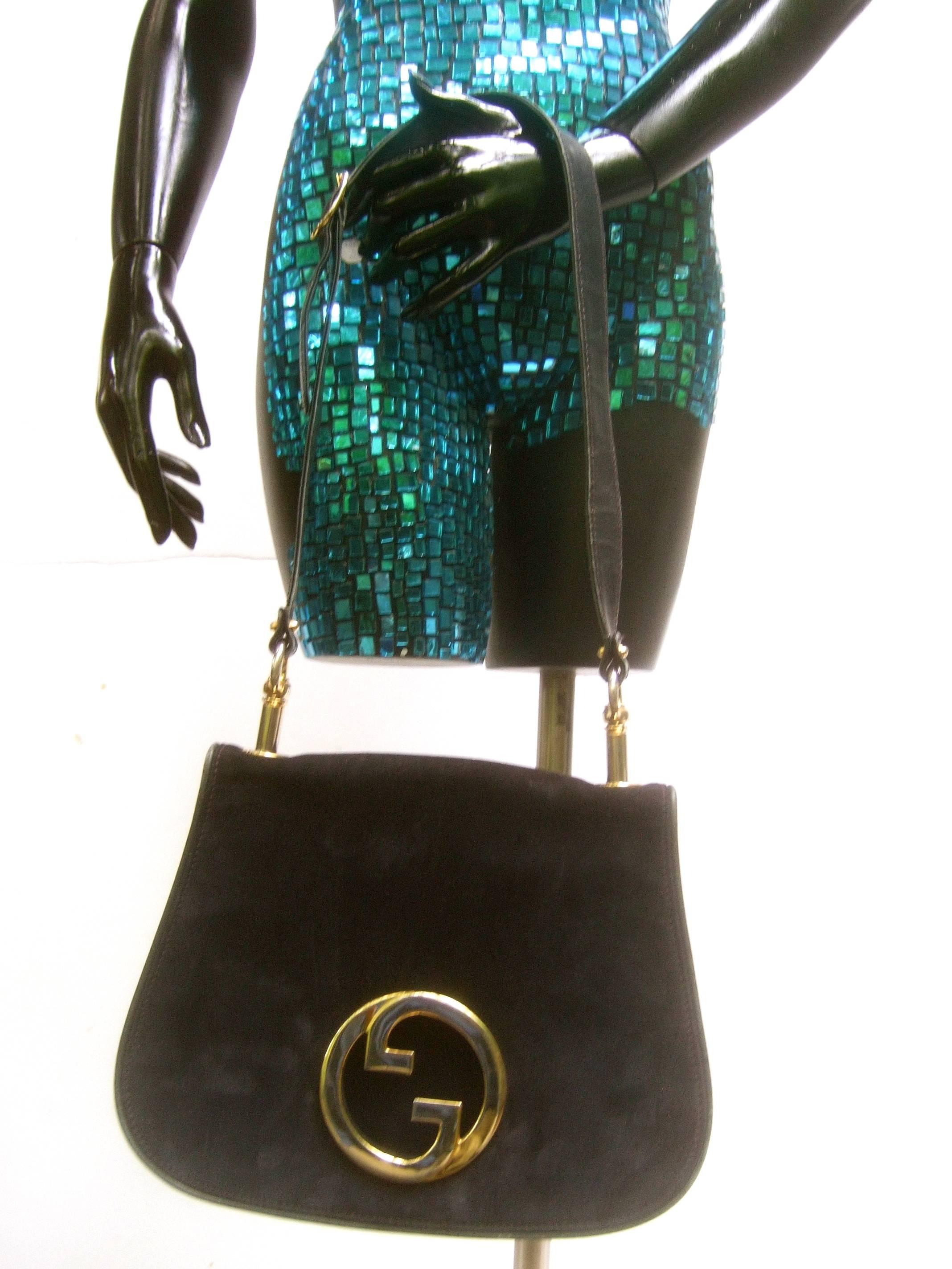 Gucci Italy Rare midnight blue doeskin suede shoulder bag c 1970s
The iconic Italian handbag is adorned with Gucci's massive 
gilt metal interlocked G.G. initials 

The handbag is covered with plush dark blue suede that appears
almost black in