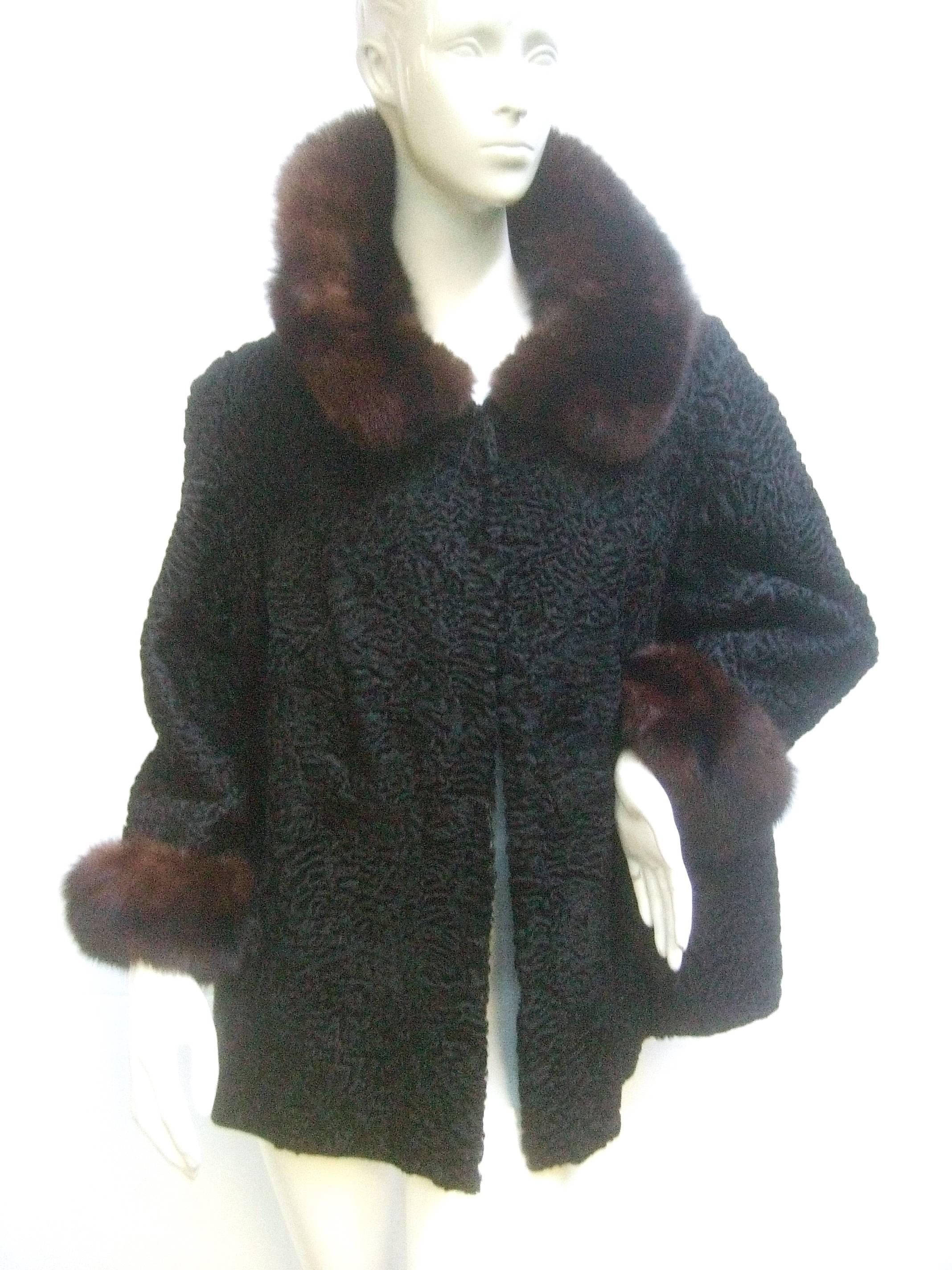 Schiaparelli Paris Luxurious sable trim astrakhan 3/4 length jacket c 1960
The chic retro jacket is designed with plush sable fur that frames
the collar and circles the sleeve cuffs 

The ebony black astrakhan fur has a soft luxurious texture
Lined