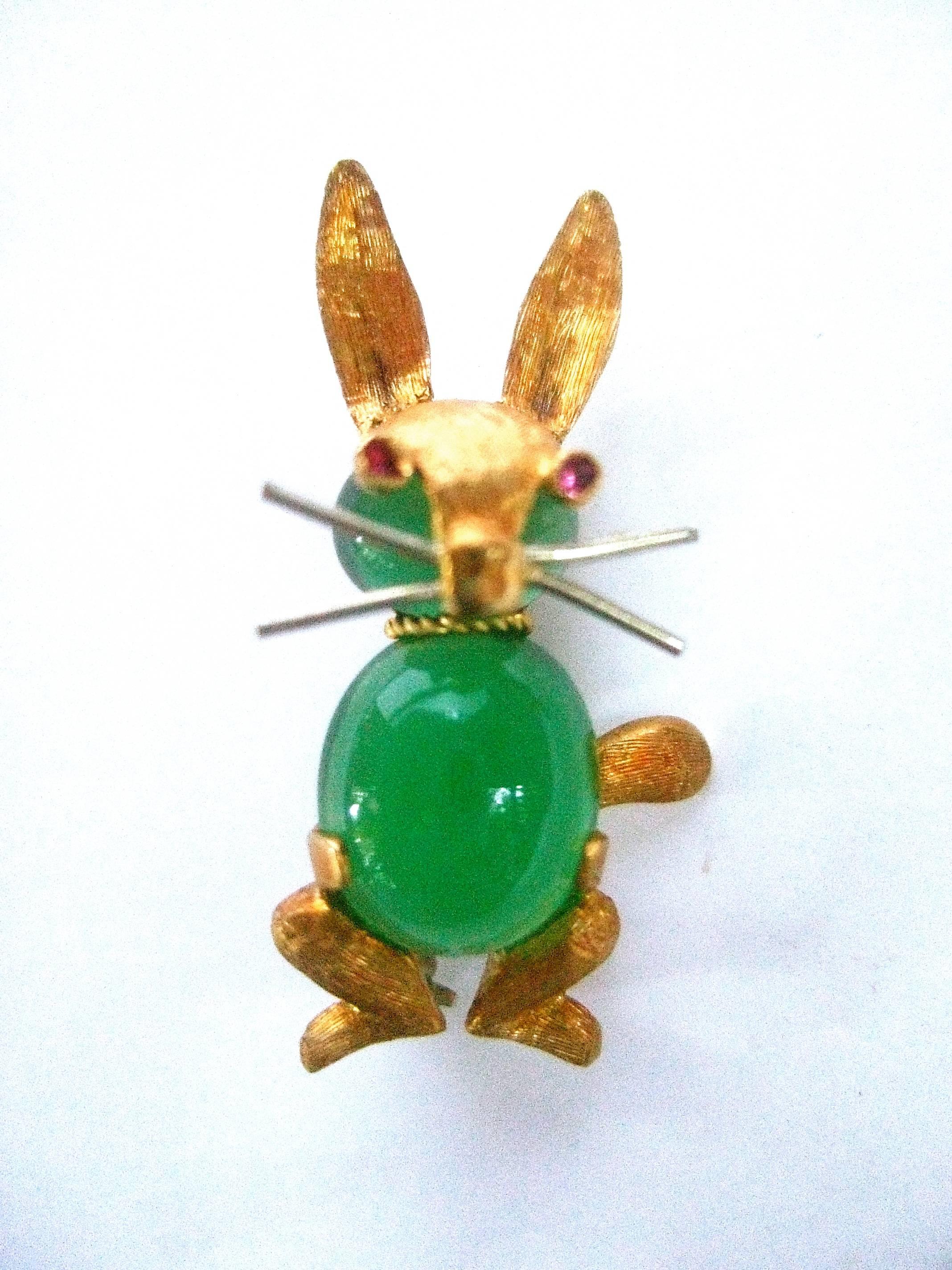 Charming 18k gold semi precious diminutive Italian rabbit scatter pin c 1960
The adorable tiny rabbit is embellished with an emerald green 
color semi precious glass cabochon jelly belly body

The eyes are distinguished with tiny pink semi precious