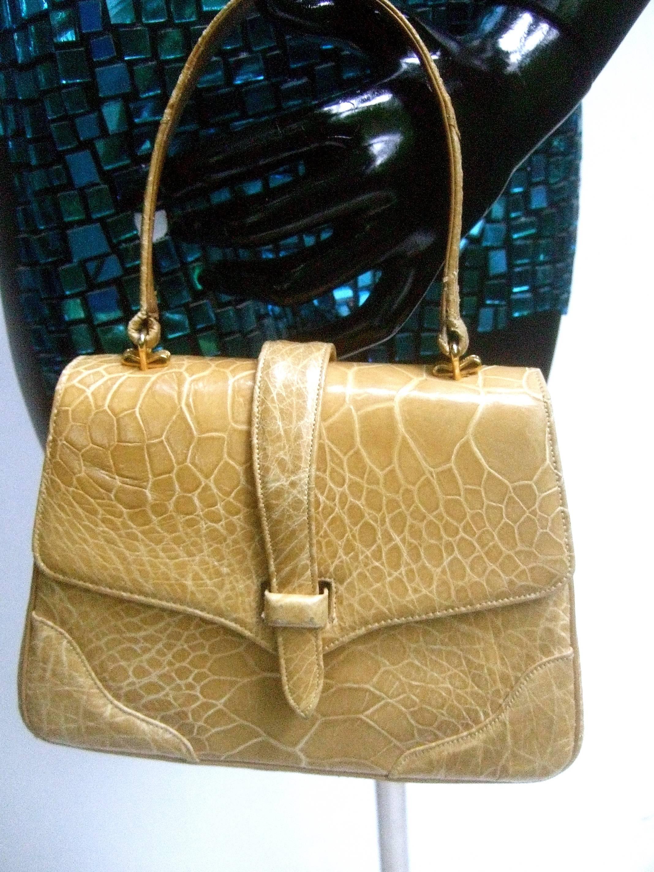 Lucille de Paris stylish turtle skin handbag c 1960
The chic retro handbag is designed with a tan 
reptile skin covering

The diminutive reptile handbag is lined in tan leather 
designed with dual slip pocket compartments 
and a zippered compartment