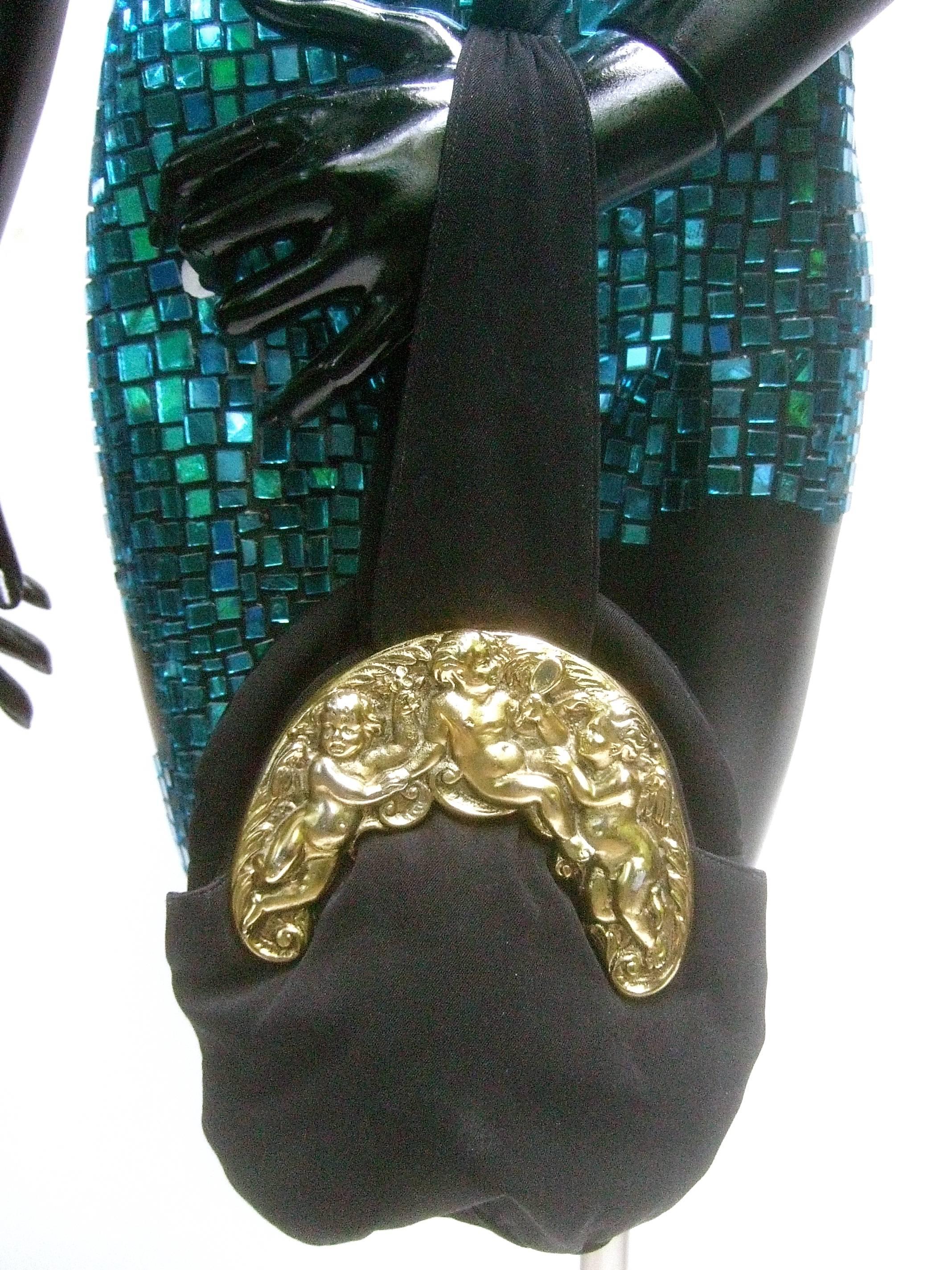 Women's Ornate Brass Metal Cherub Emblem Black Cloth Evening Bag c 1950s For Sale