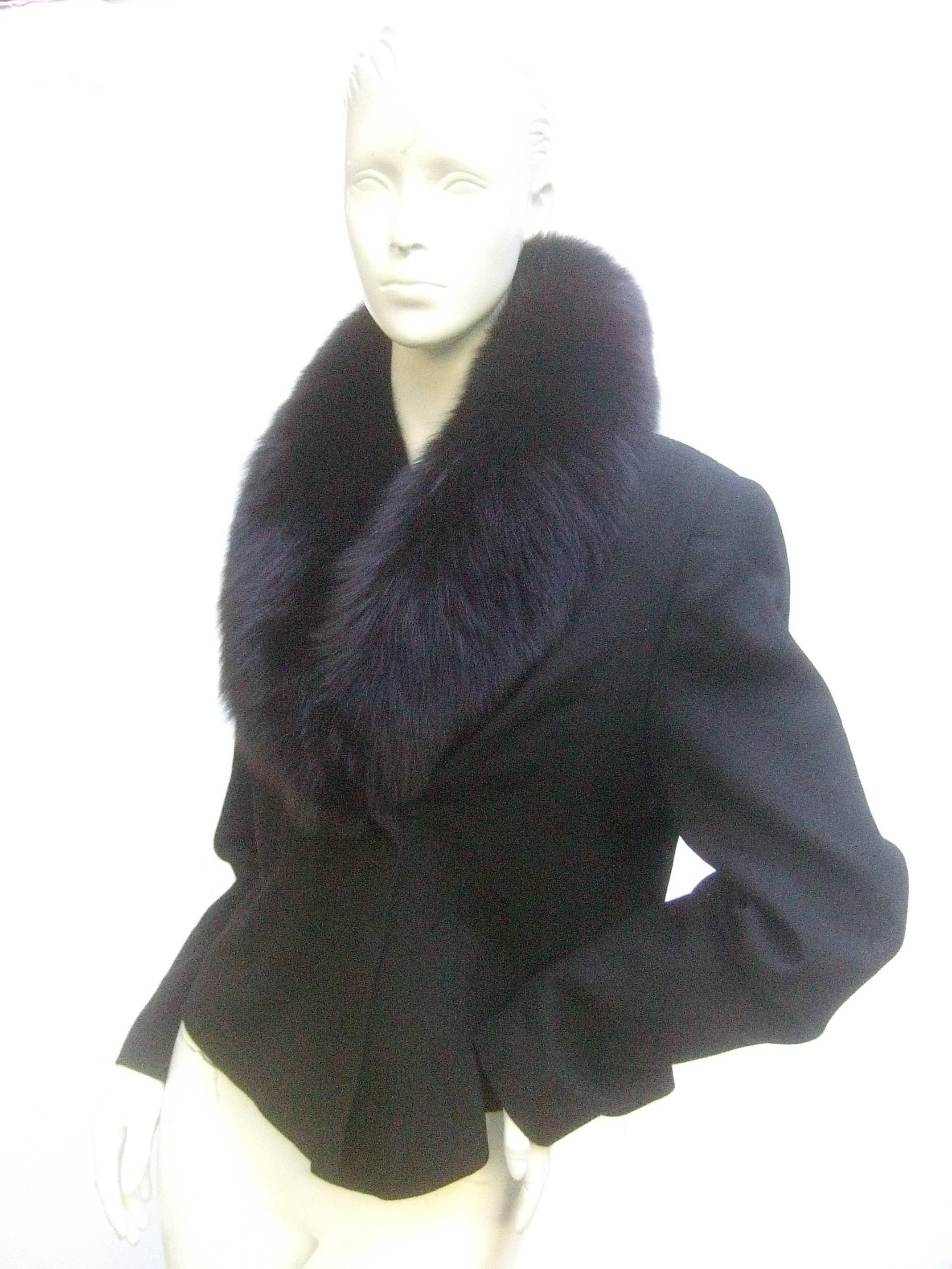 Neiman Marcus fox collar black wool jacket c 1980s
The stylish vintage is designed with a plush voluminous
black dyed fox fur collar

Secures with a single button closure. Designed with stationary
built in shoulder pads. The shell is 100% worsted