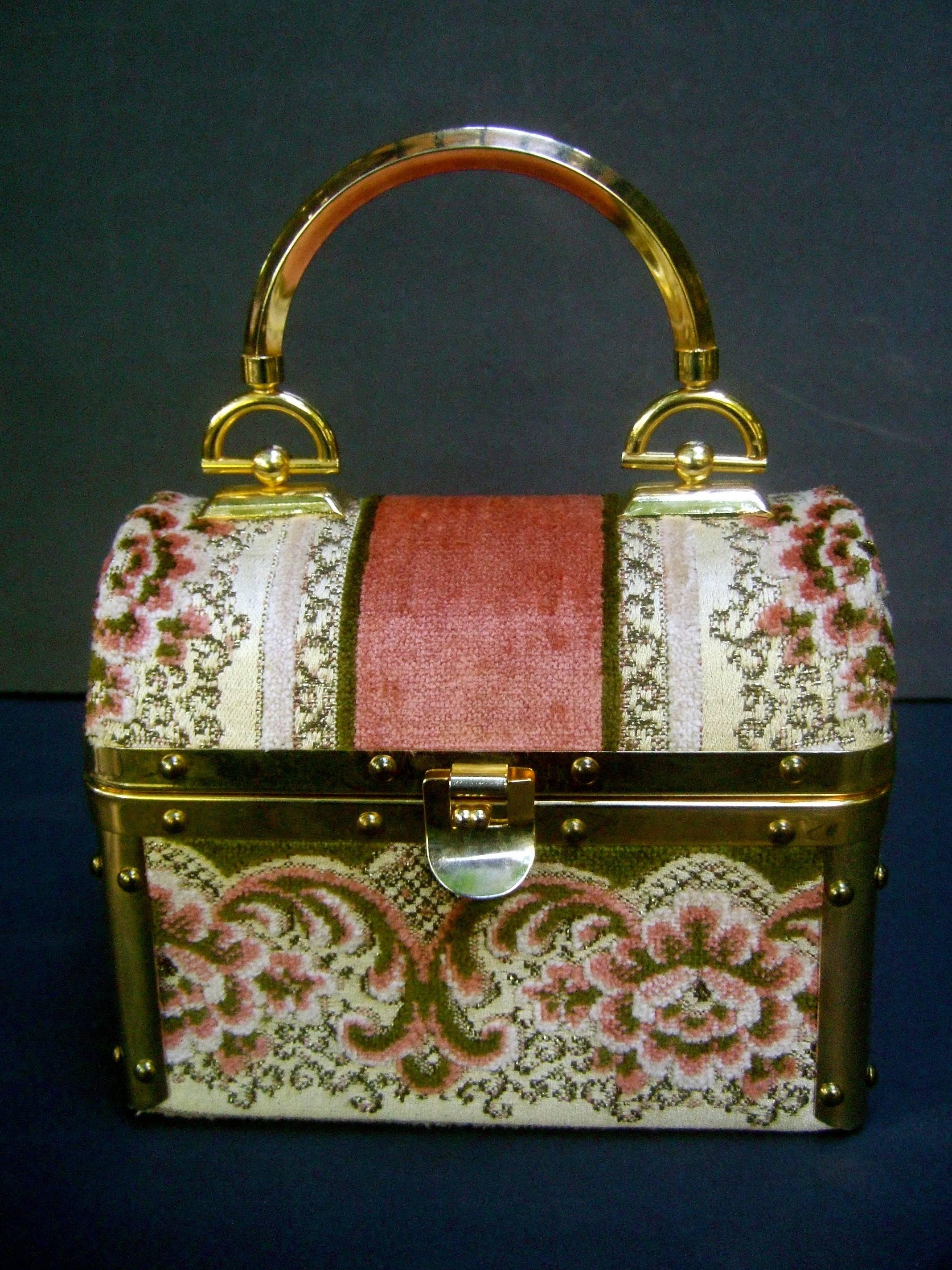 Borsa Bella Italian brocade box purse c 1970s
The chic retro handbag is covered with plush 
floral brocade juxtaposed with wide solid 
panels 

Adorned with sleek gilt metal hardware trim
and a gilt metal swivel handle. The interior is
lined in