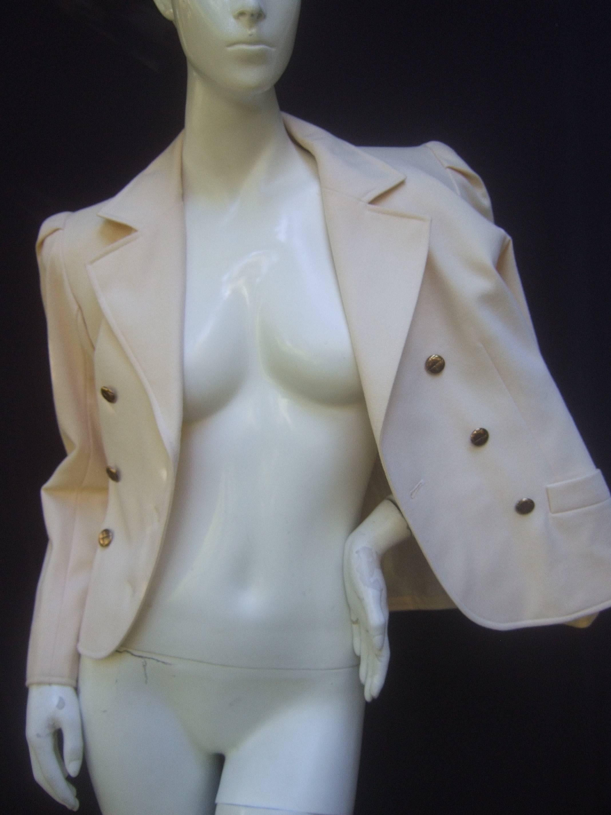 Saint Laurent Rive Gauche cream wool jacket c 1970s
The stylish jacket is designed with a set of six 
gilt metal buttons that run across the front 

The shoulders have a restrained pleated detail 
The lower front is designed with a pair of pockets