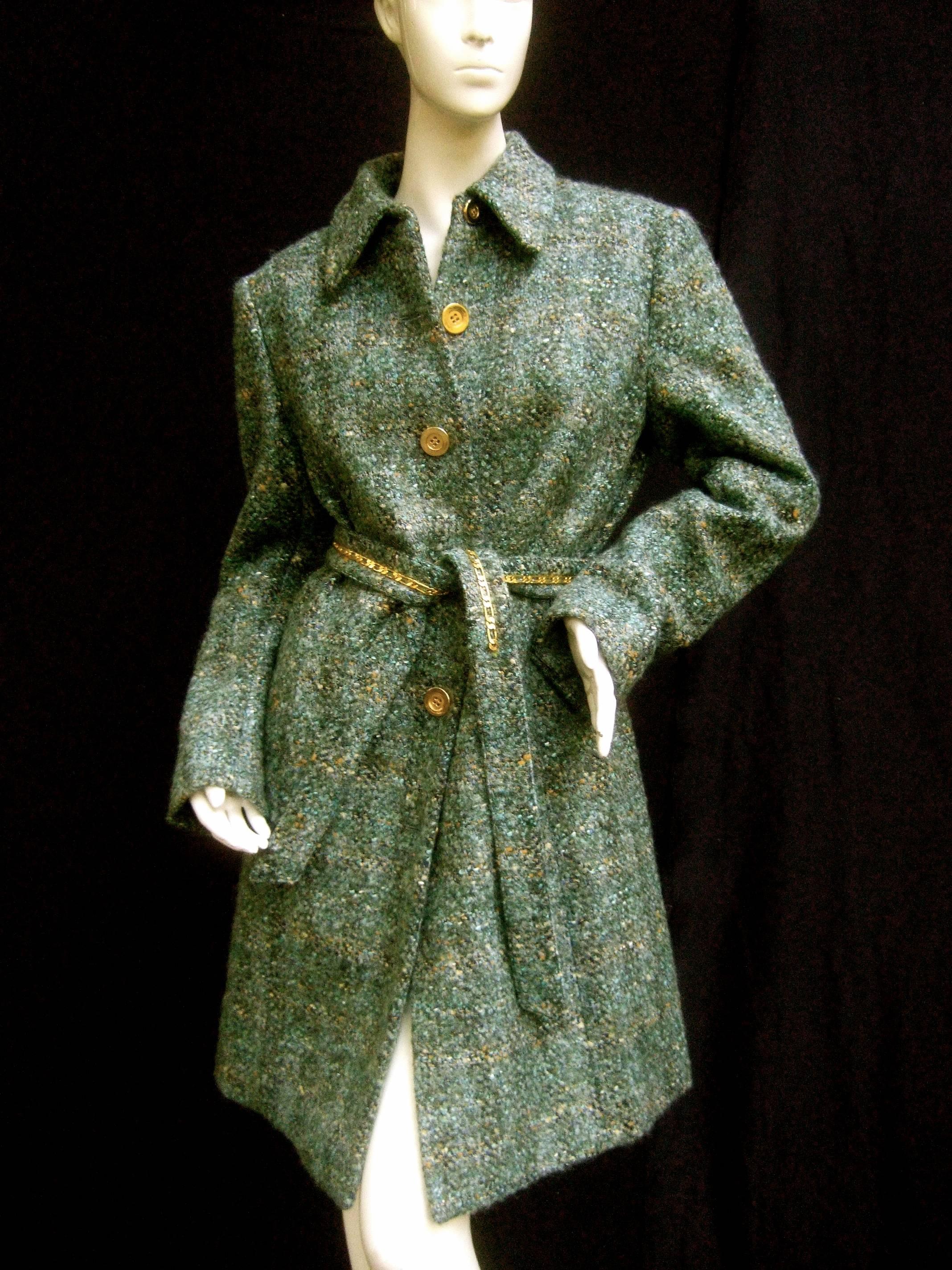 Worth chunky wool knit gilt button belted coat US Size 8 
The stylish belt coat is designed with muted 
pale blue and green wool knit 

Paired with a series of gilt metal buttons 
that run down the front. Secures with a matching
wool knit belt