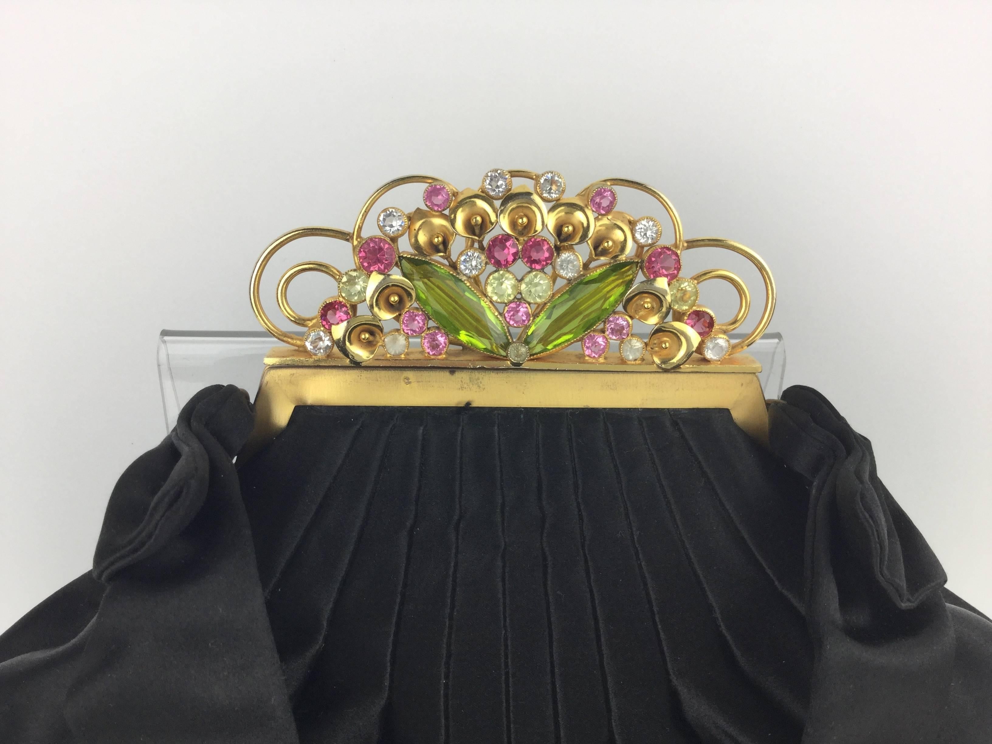 This is one of the rarest and most sought after of all vintage handbags. From Josef of Hollywood's legendary 1930's limited series of floral jewel clasp delights.  Made of rich black pleated satin silk crowned with a spectacular jewel encrusted