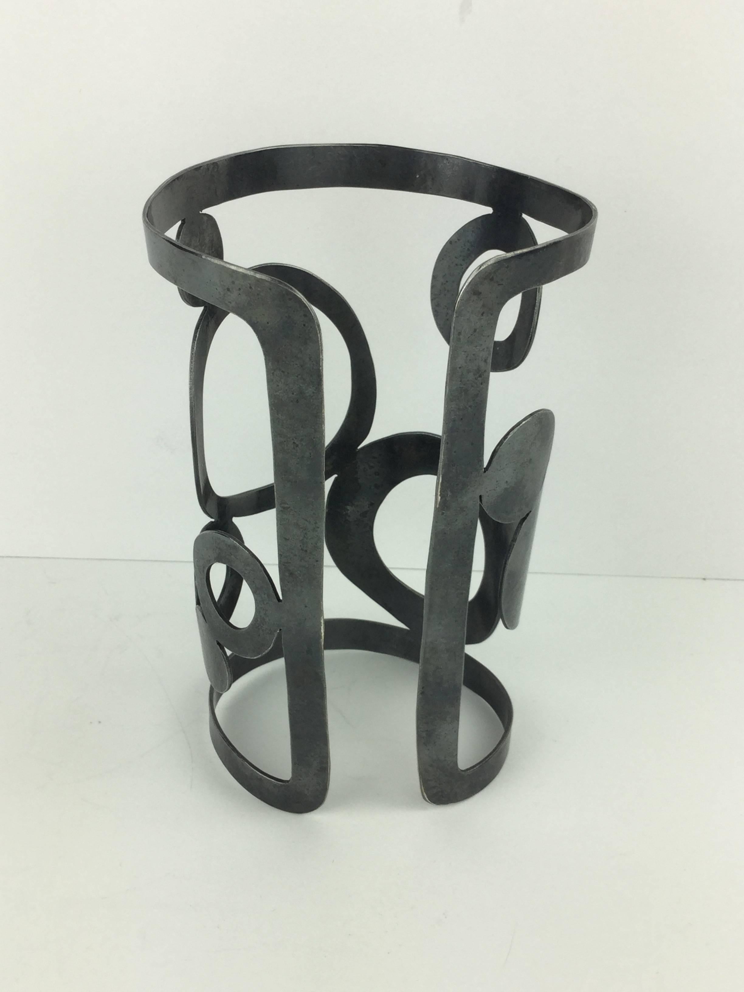 Incredible huge gladiator style metal cuff by Herve Van Der Straeten featuring geometric cut outs.
Widens going up from the wrist to enclose the lower arm. Excellent Condition. Signed: HV
Size:  5 inches tall. 3 inches wide at it's widest.  The