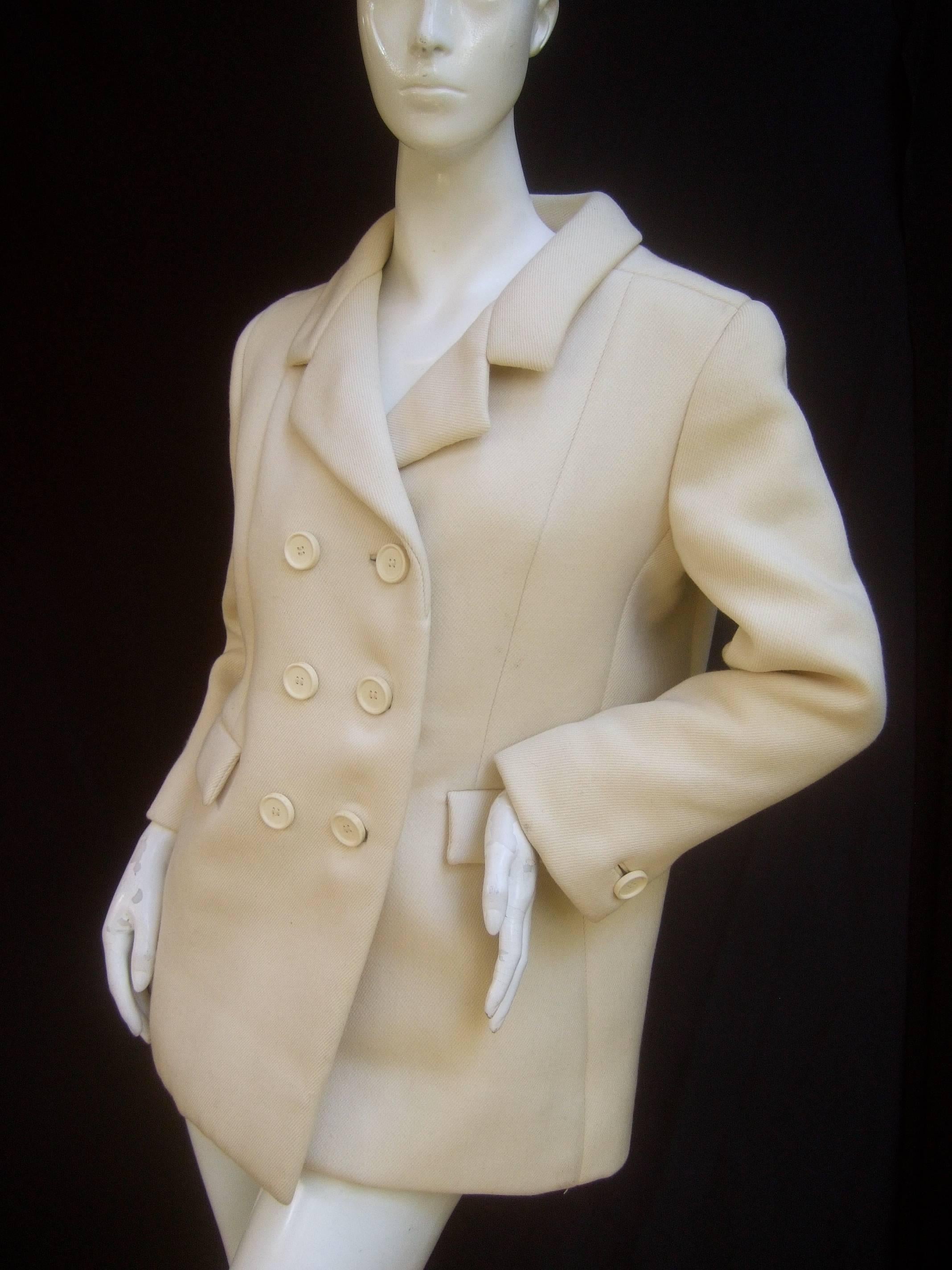 Norman Norell Couture cream wool jacket c 1970 
The chic retro jacket is designed structured cream
color wool

Adorned with six large white resin buttons on the 
front. Designed with a pair of flap covered pockets
on the front midsection

Labeled: