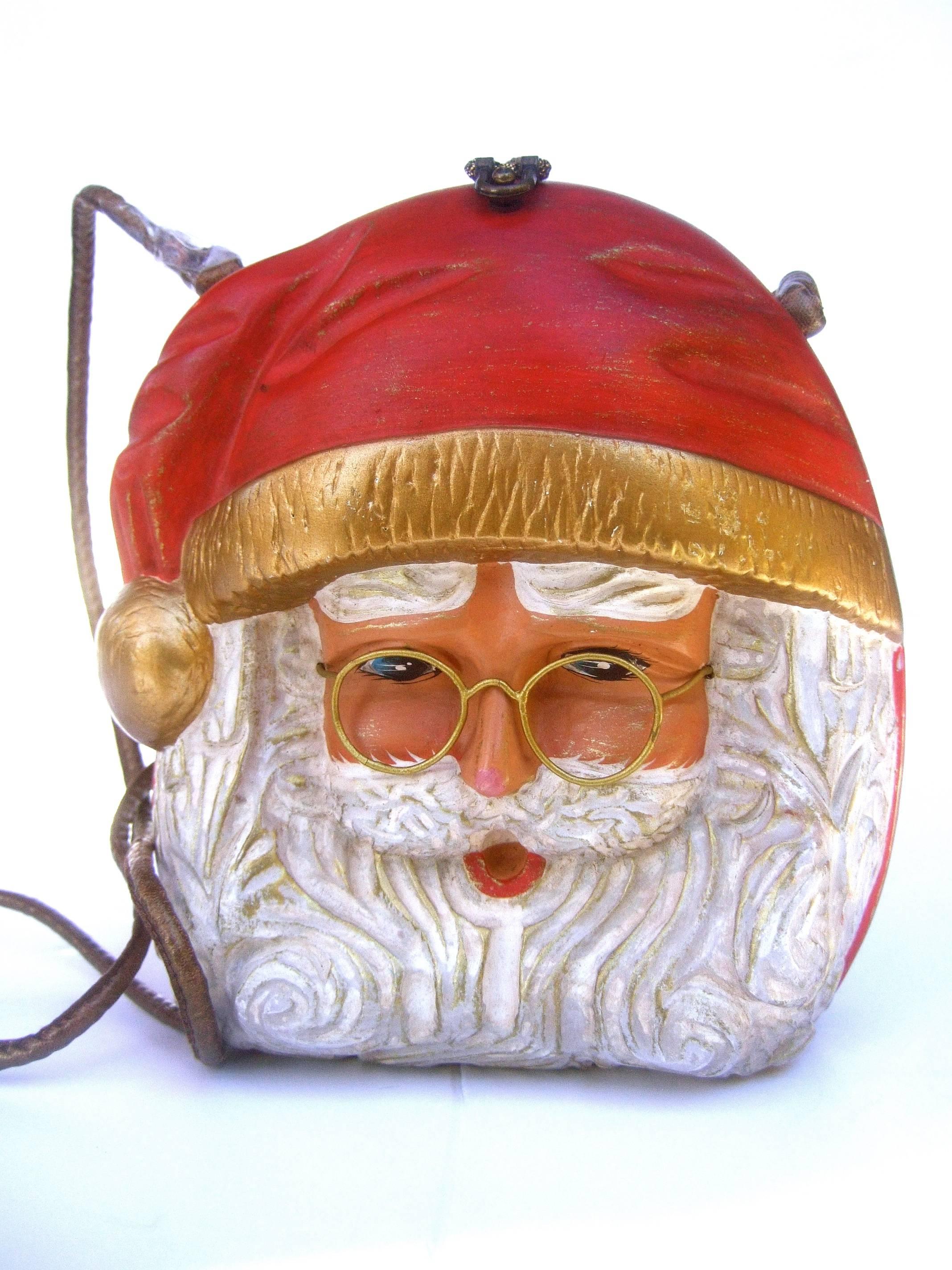 Timmy Woods Beverly Hills Whimsical artisan Santa Claus handbag
The charming hand carved wood handbag depicts jolly old St Nick

His features are illuminated with hand painted enamel detail
Paired with wire frame spectacles and a bushy carved beard