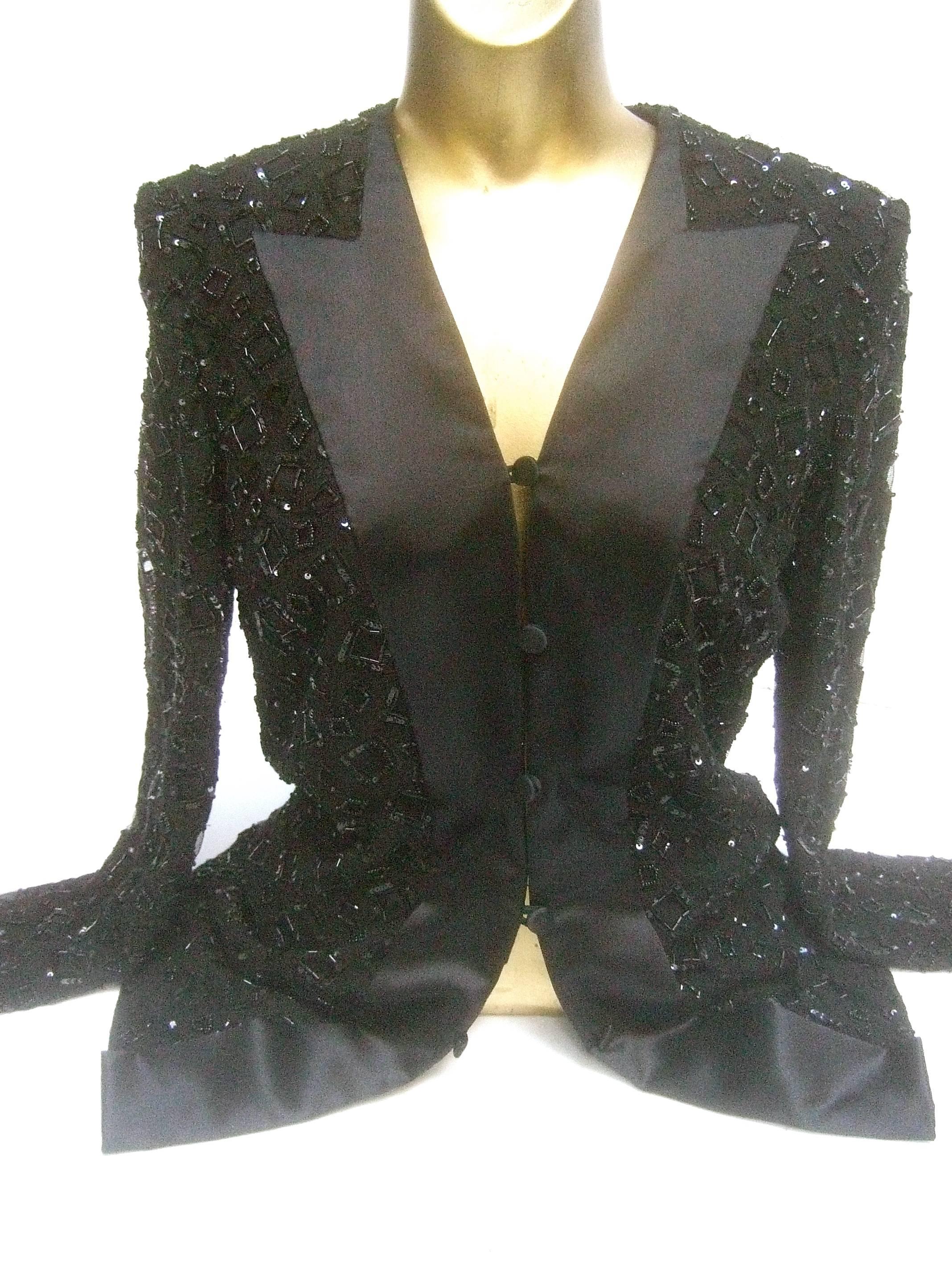 Mirella Cavorso Italian silk black beaded tuxedo style evening jacket 
The elegant jacket is embellished with glass bugle beads 
combined with tiny sequins in square shaped configurations 

The stationary lapels are luminous black silk designed in