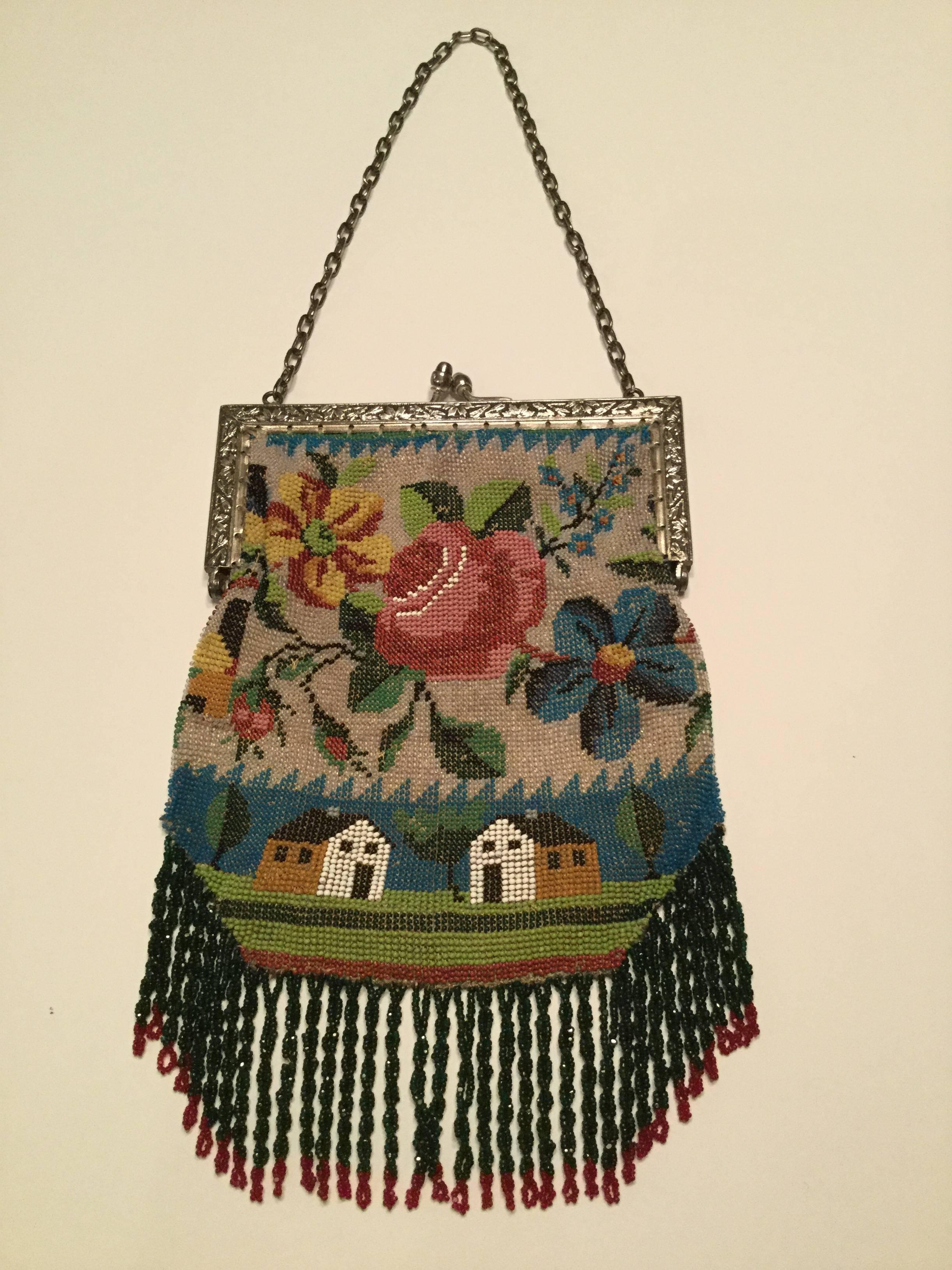 Victorian micro-beaded scenic fringed bag depicting two Shaker style
cottages in a stylized landscape. A profusion of cabbage roses and other florals grace the upper section. The beads here are just tiny and must have taken an incredible length of
