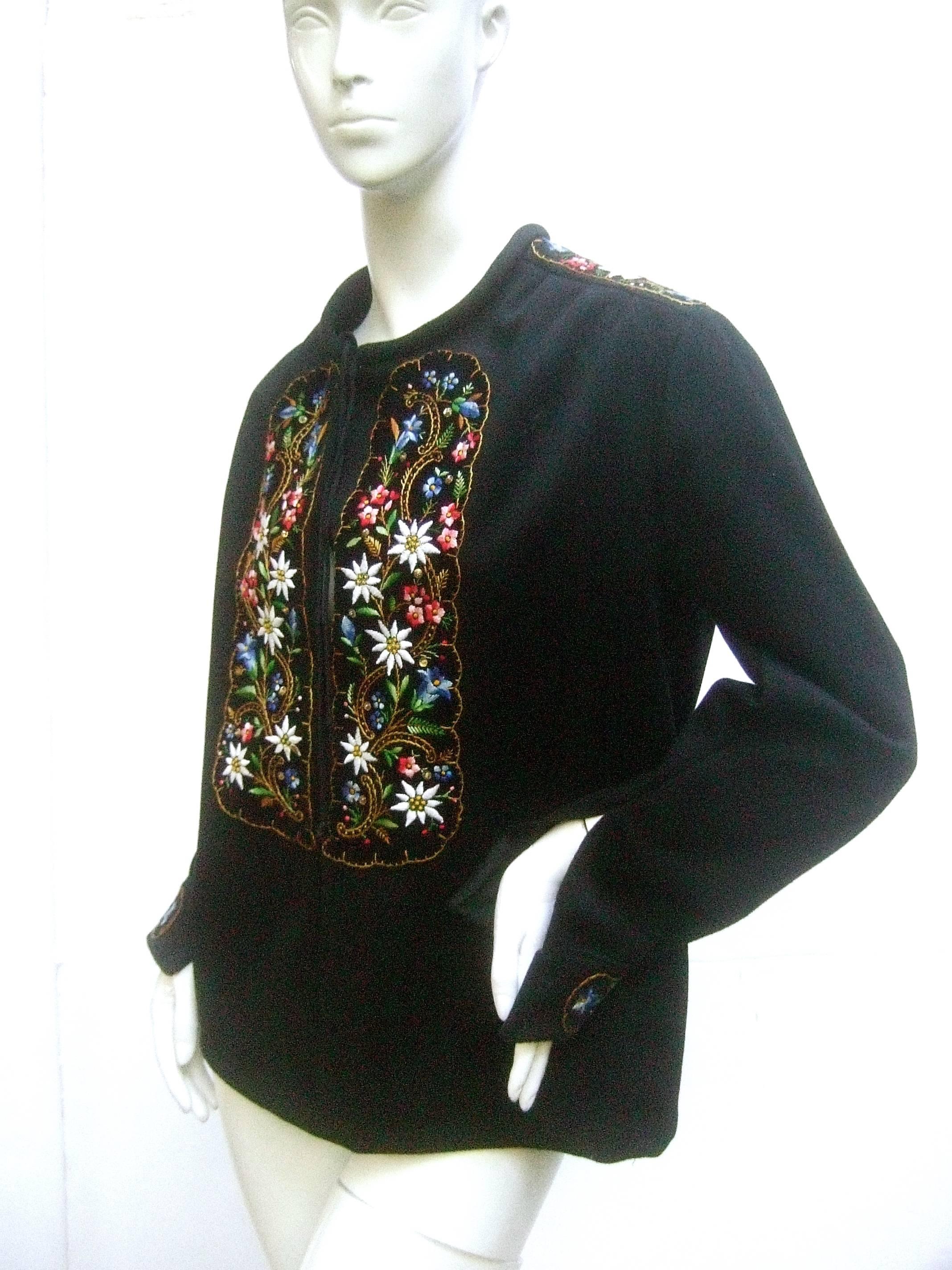 Saks Fifth Avenue embroidered black wool tunic c 1970s 
The unique wool tunic is embellished with intricate floral 
embroidery that runs down the center, across the shoulders 
and extends to the cuffs

The floral embroidery is illuminated against a