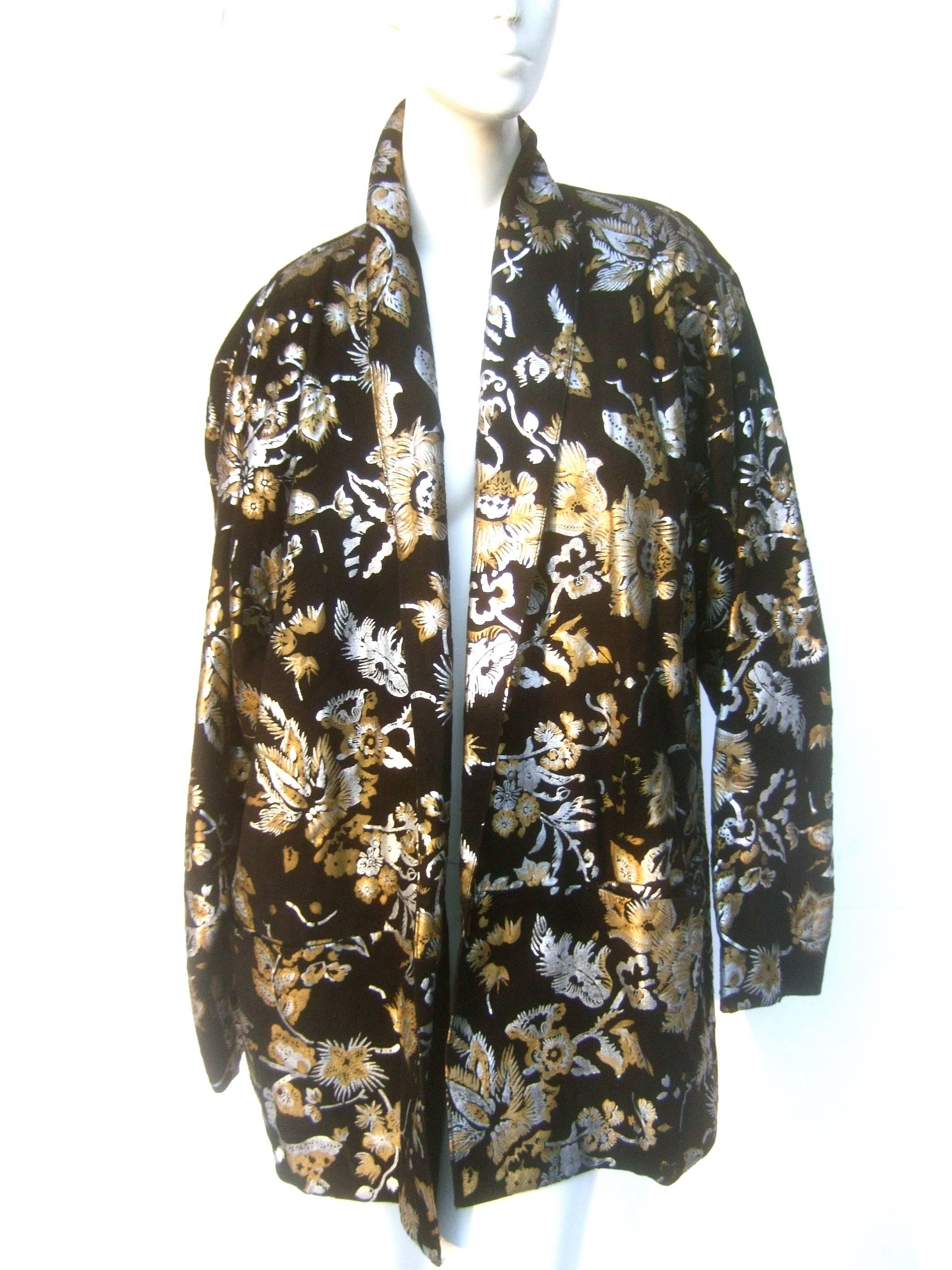 1980s Black suede floral print metallic jacket 
The plush black suede jacket is illuminated 
with a series of vibrant flowers in silver 
and gold metallics

The boxy style jacket is designed with a pair
of deep patch pockets on the lower