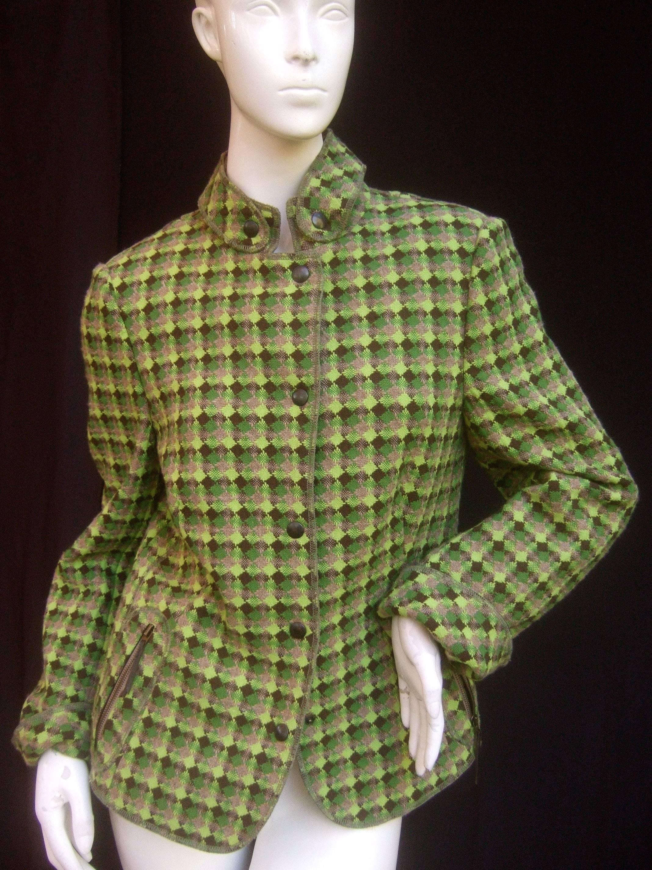 Akris Punto green plaid wool jacket 
The stylish jacket is designed with green
and brown wool geometric knit throughout

Secures with a set of metal snap buttons
The lower front sides have diagonal zippered
pockets 

Labeled Akris Punto (US Size 14)