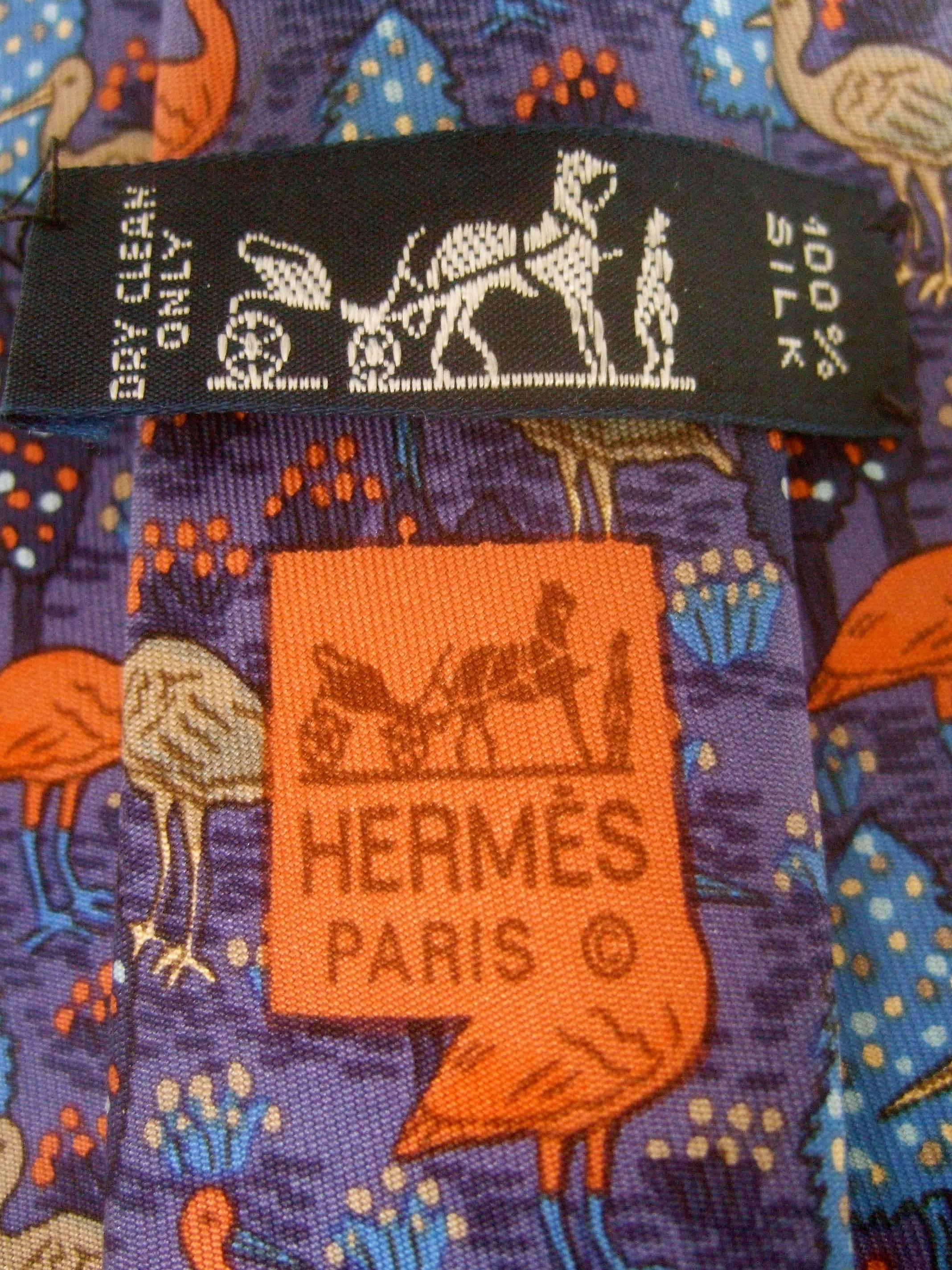 HERMES Paris Silk bird theme necktie c 1990s
The elegant designer silk necktie is illustrated 
with a series of birds wading in a watery marsh 
setting with flowering foliage in pastel colors 

Designed by Hermes Paris 100% Silk  

The widest